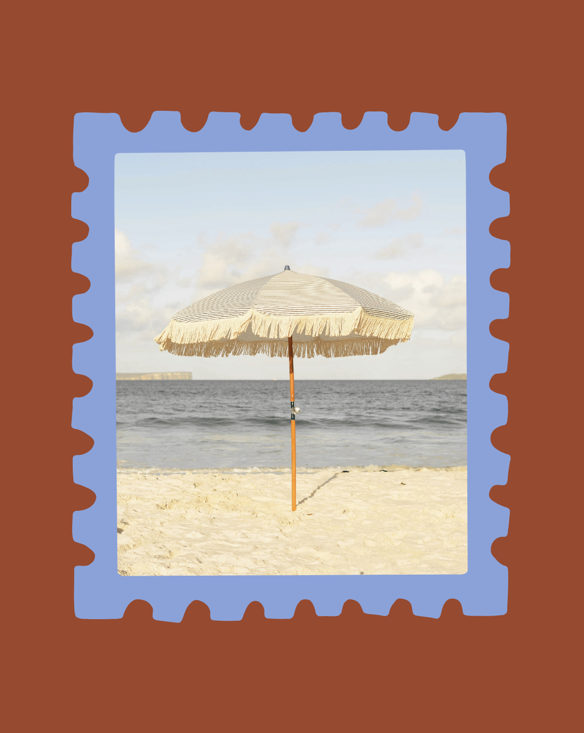Beach scene with sandy shore, a thatched beach umbrella, ocean water, and cloudy sky.