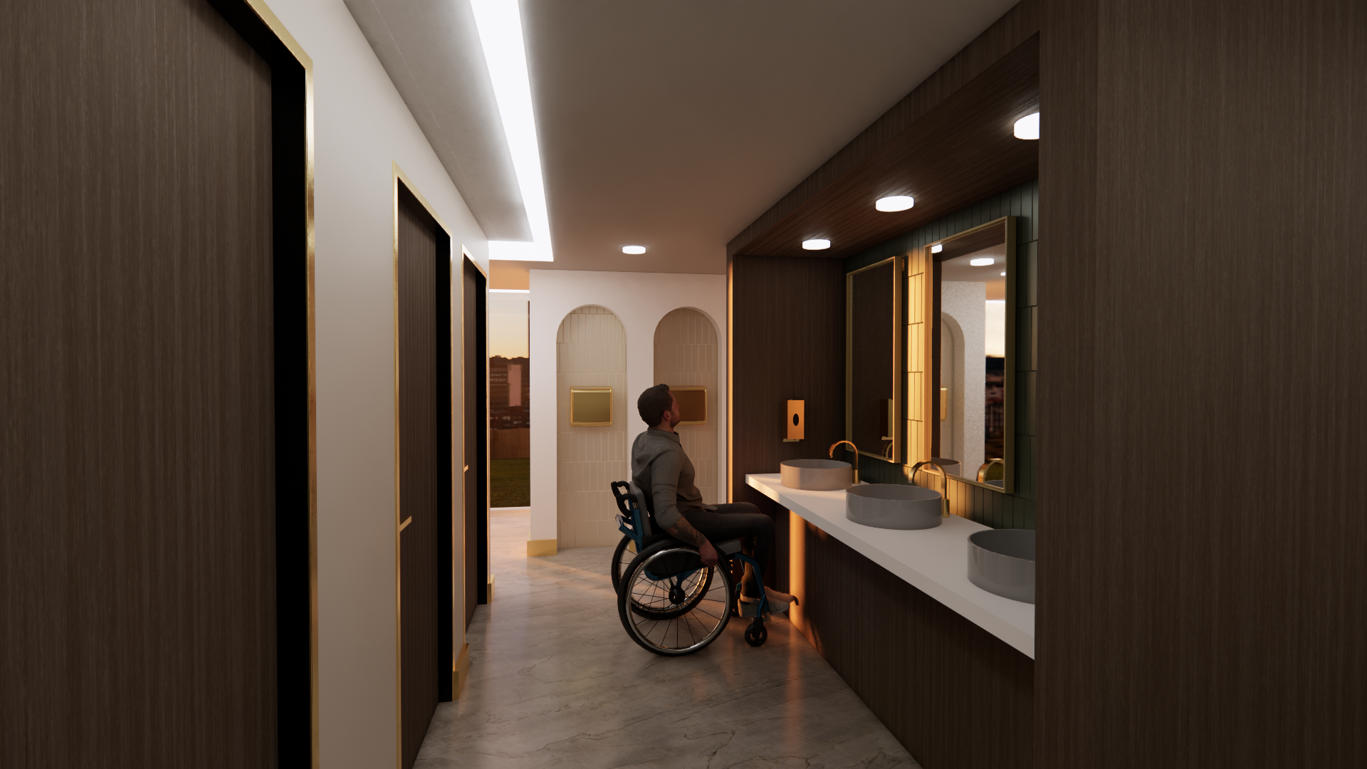 A person in a wheelchair looking at a bathroom sink area inside a modern building with warm lighting.