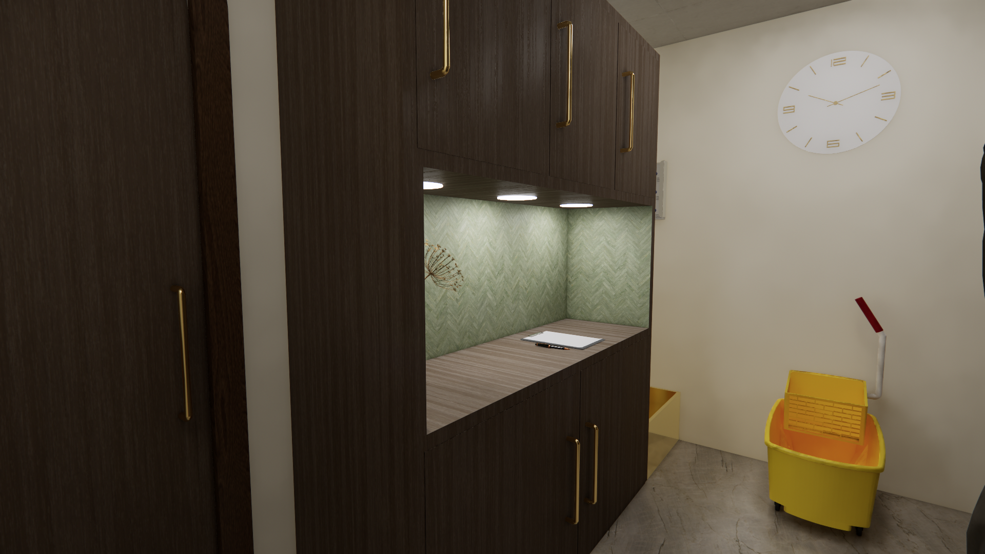 A room with dark wood cabinet with gold handles, a green patterned backsplash and a small workspace with a notepad and pen, a large white clock on the wall, and a yellow mop bucket with a red and white mop handle.