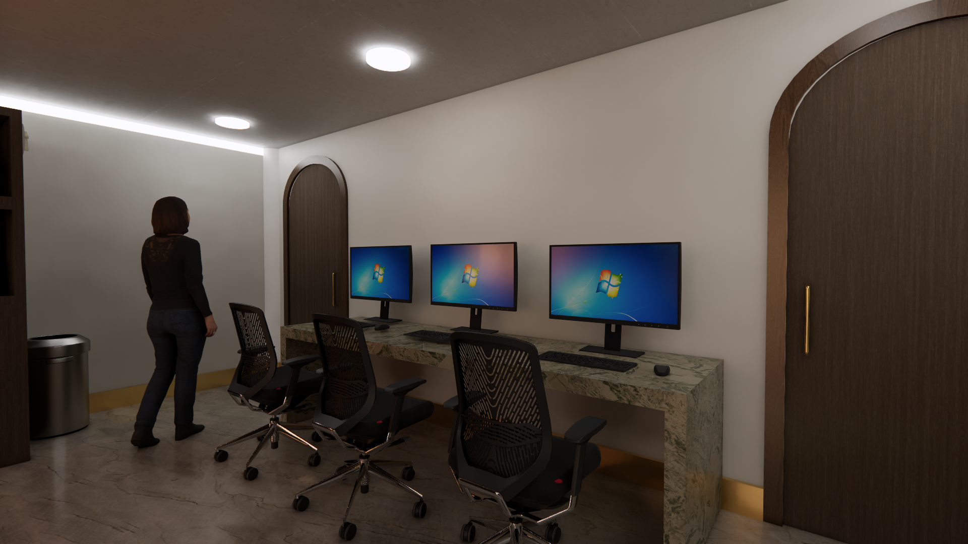 Woman standing in a modern office room with three computer monitors on a marble desk, two empty office chairs, wooden sliding doors, and a trash can.
