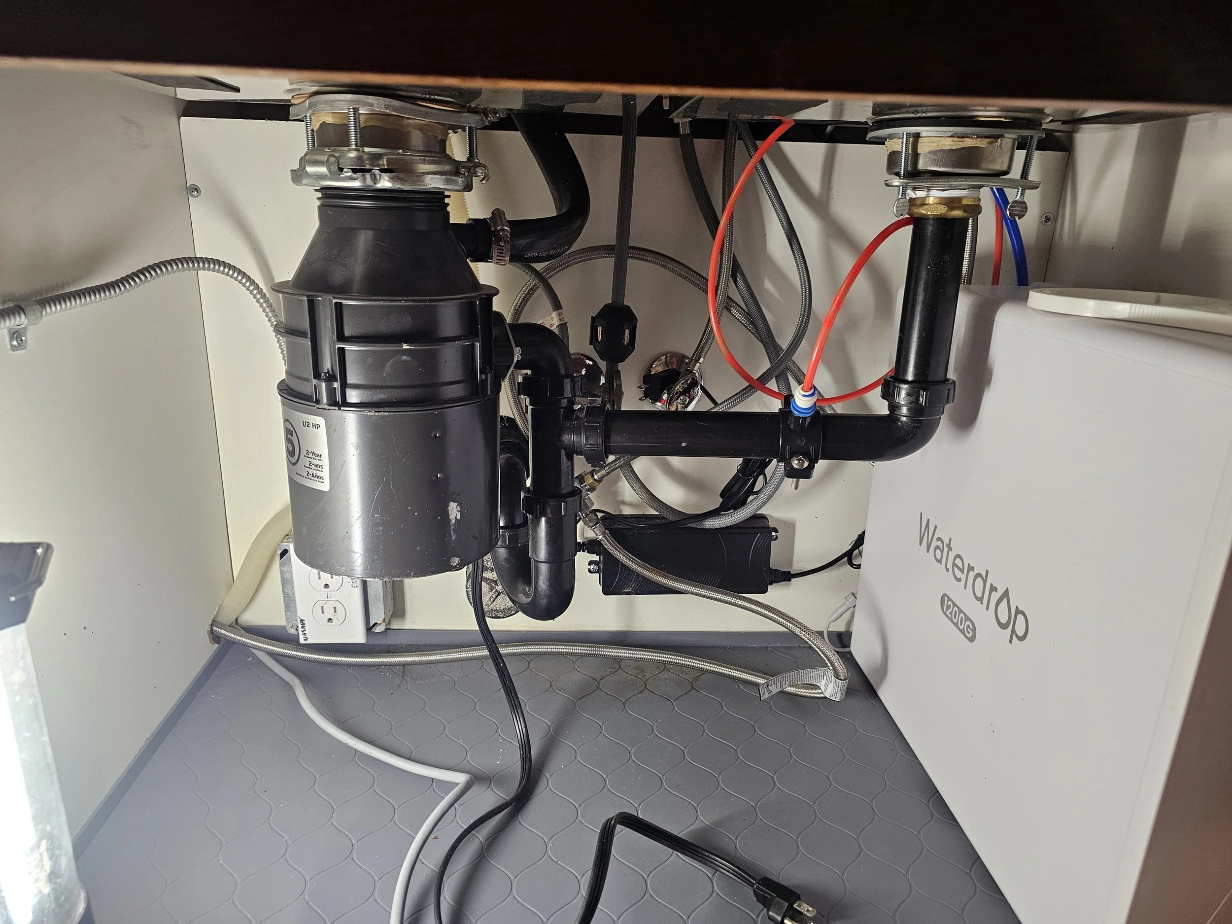 Professional under-sink garbage disposal and plumbing system installation by Emerald Systems, serving residential homes in the East Bay area.