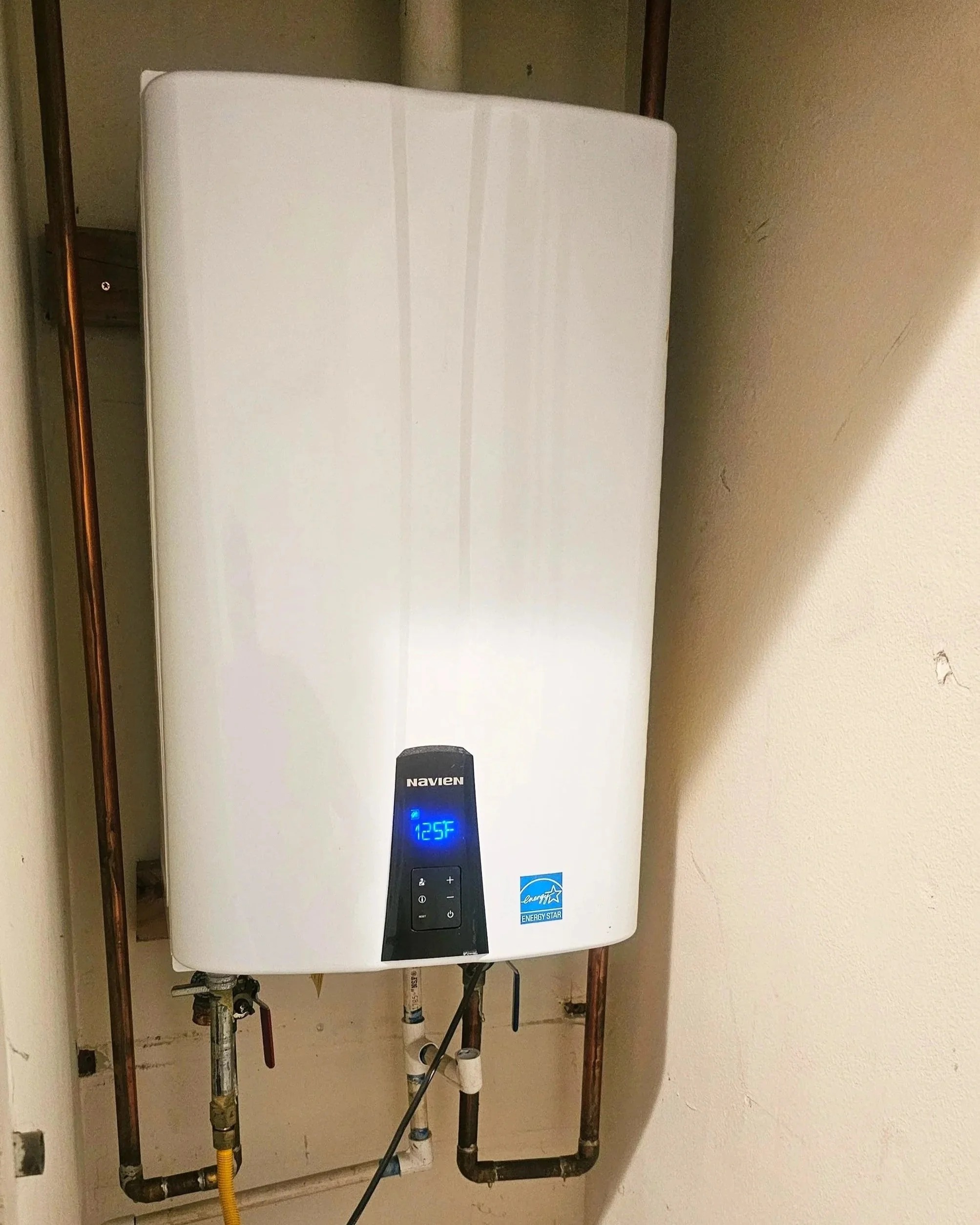 Installed Navien tankless water heater system by Emerald Systems, delivering efficient and reliable hot water solutions for homeowners in the East Bay area.