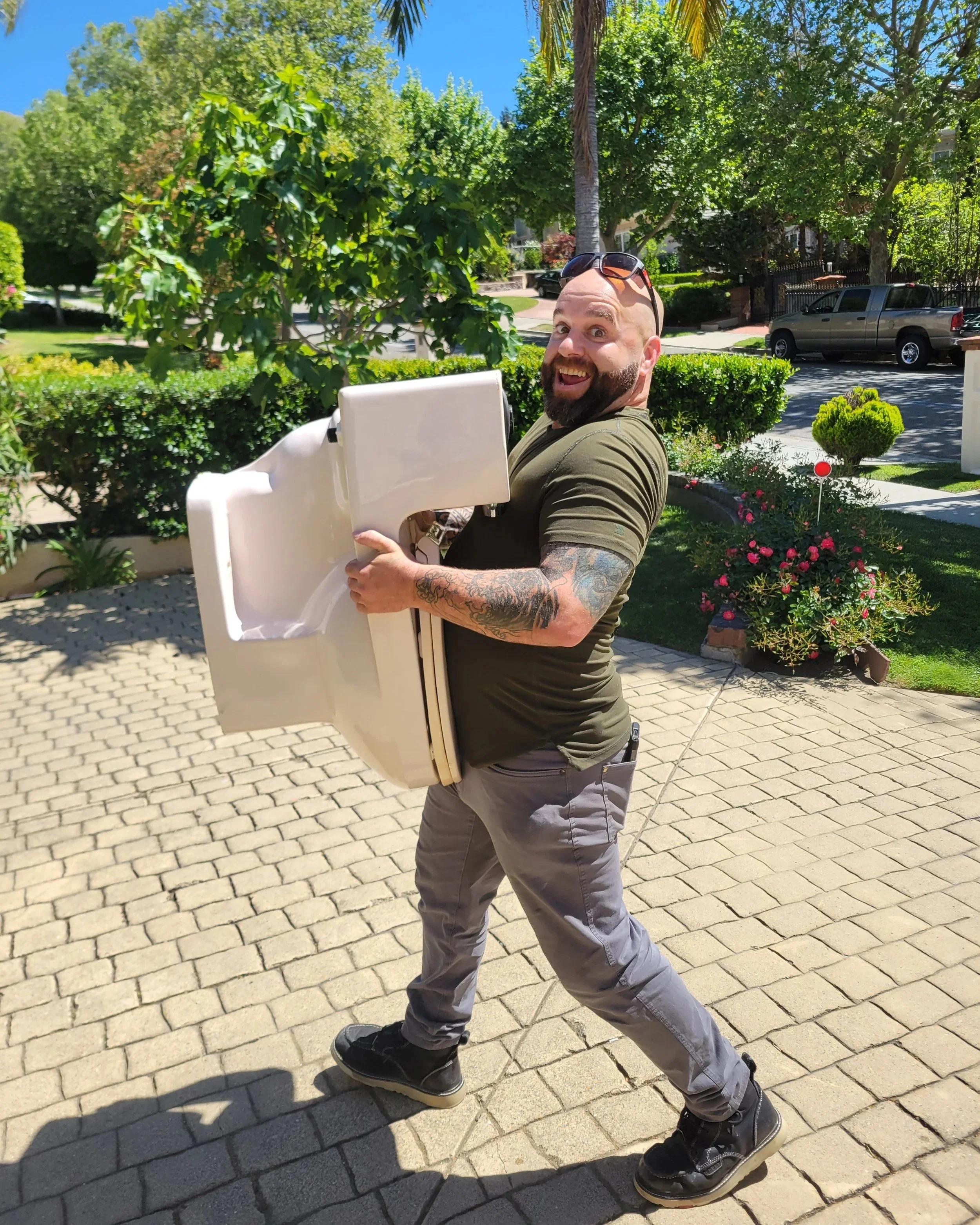 Daniel Davis of Emerald Systems carrying a toilet for installation, professional plumbing service in the East Bay area