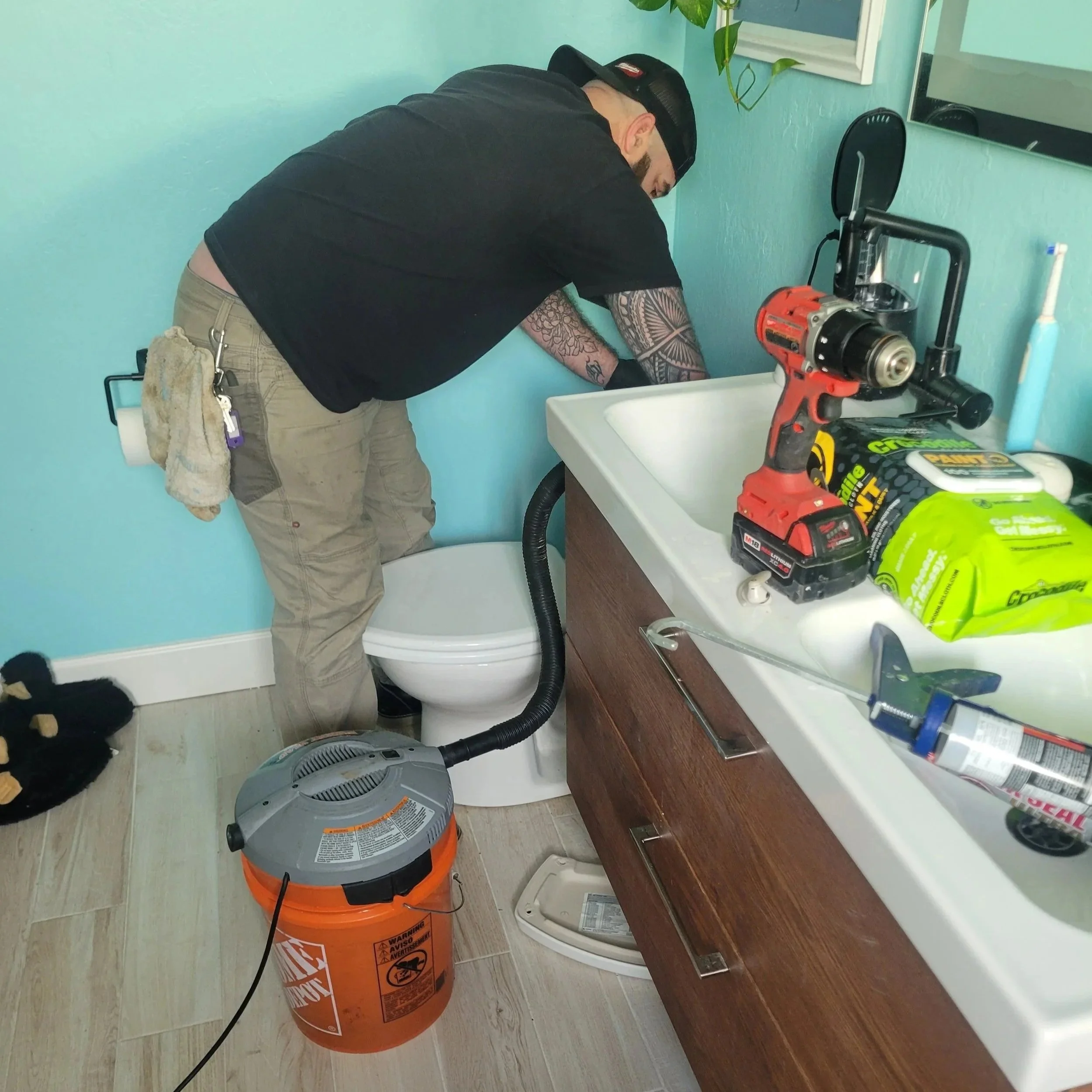 Daniel Davis of Emerald Systems providing expert toilet repair and plumbing services in a residential home, serving clients across the East Bay area.