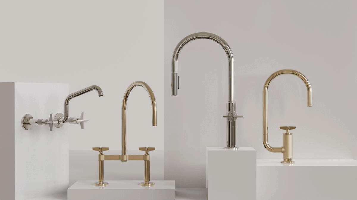 Collection of modern chrome and brass bathroom faucets displayed on white pedestals