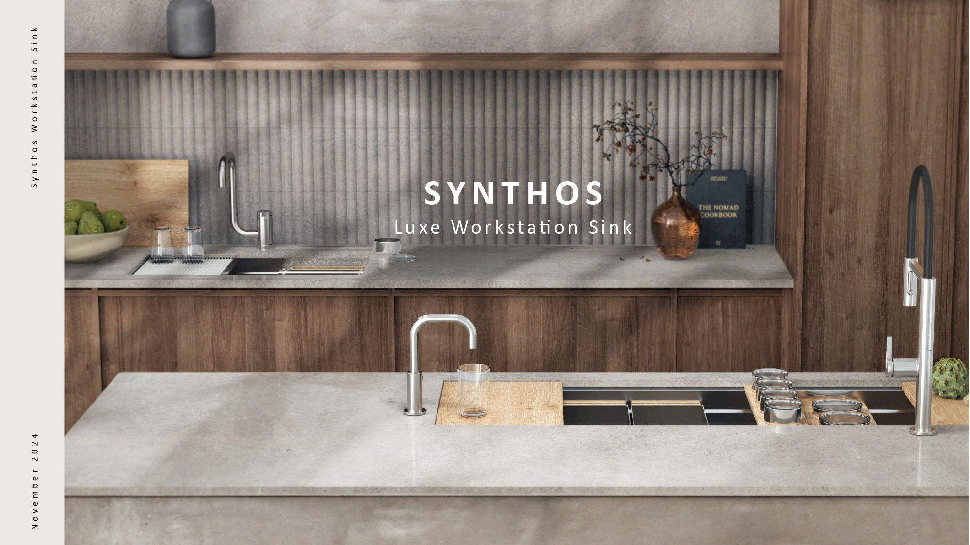 A modern kitchen with wooden cabinets, a grey countertop, and a textured grey backsplash. The countertop has a sink with a curved faucet, a bowl of green apples, a cutting board, and glasses. There is a decorative brown vase with branches and a dark book next to it on the counter.