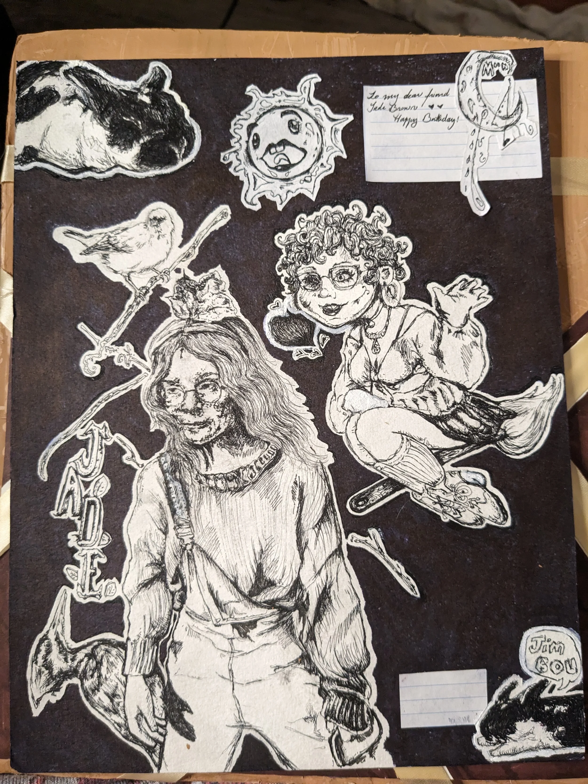 A black and white illustration of various characters and objects on a black background, including a woman with glasses, a young girl sitting on a witch's broomstick, a dog, a bird, a smiling sun with a face, a moon with a face, and a note that says "To my dear friend Jade Brown, Happy Birthday!"