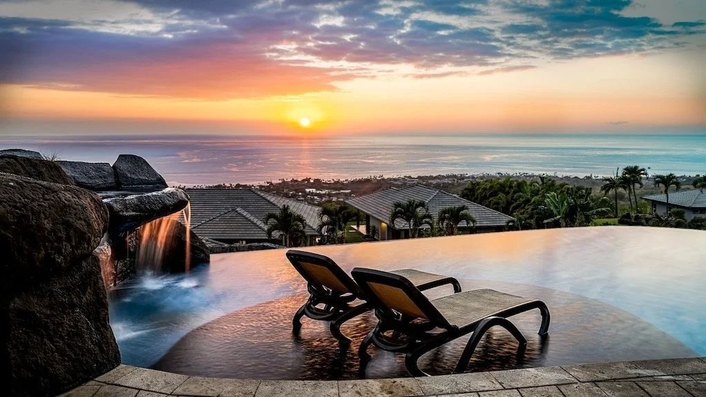 Cliff side villa overlooking the Pacific Ocean at sunset.