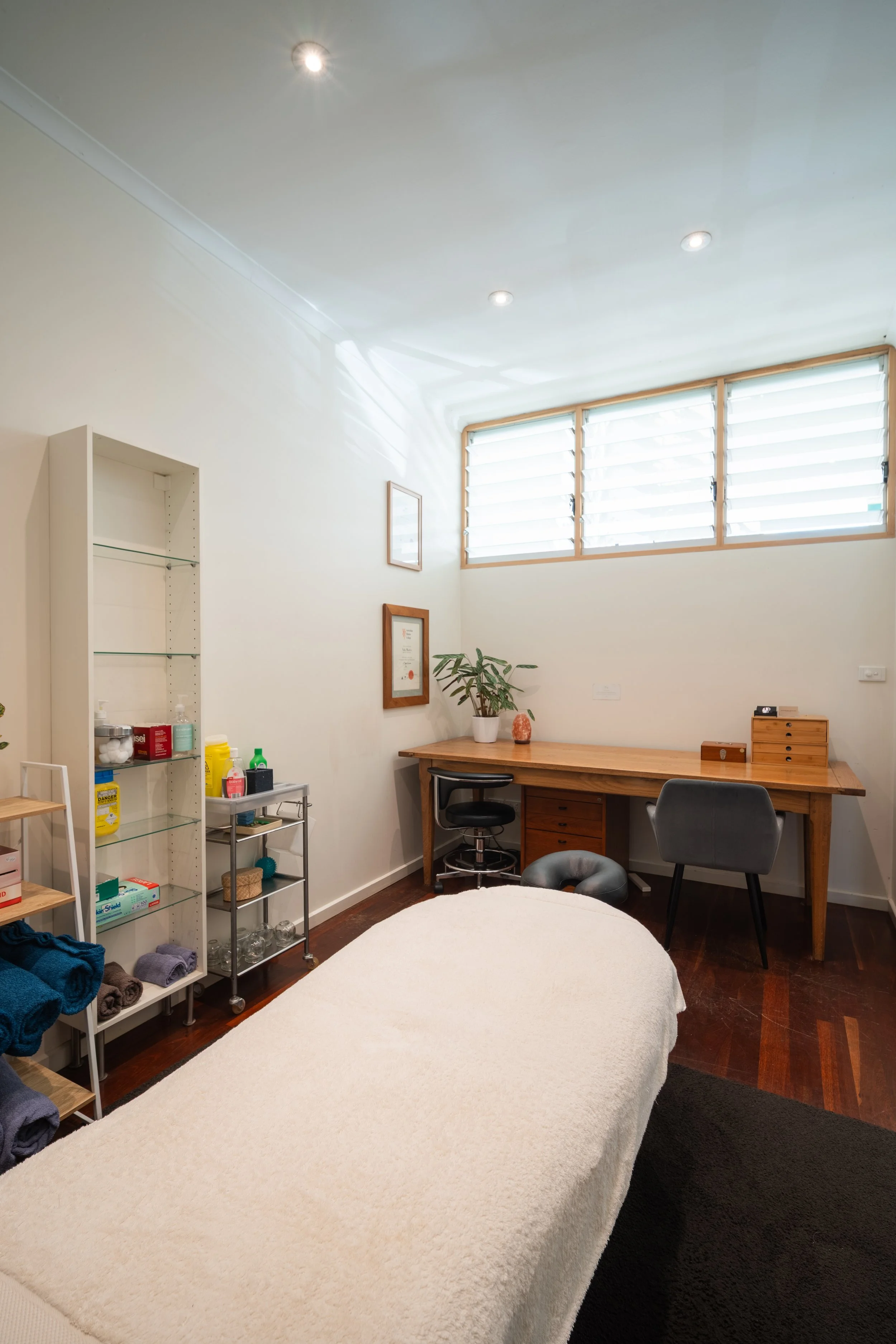 Calm treatment room with desk and natural light at Four Seasons Wellness Centre Abbotsford Melbourne