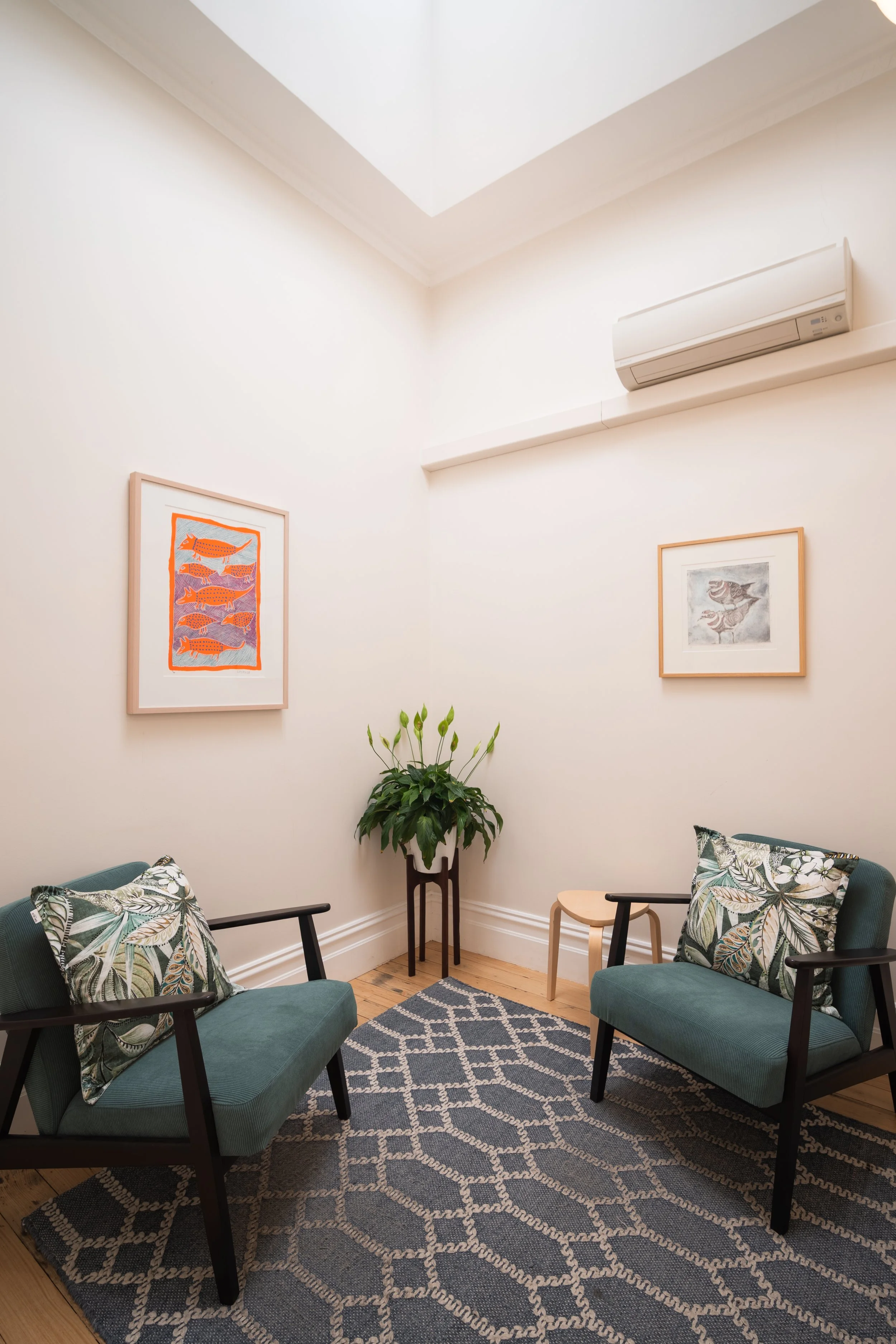 Light-filled consultation room with armchairs and artwork at Four Seasons Wellness Centre, Abbotsford Melbourne