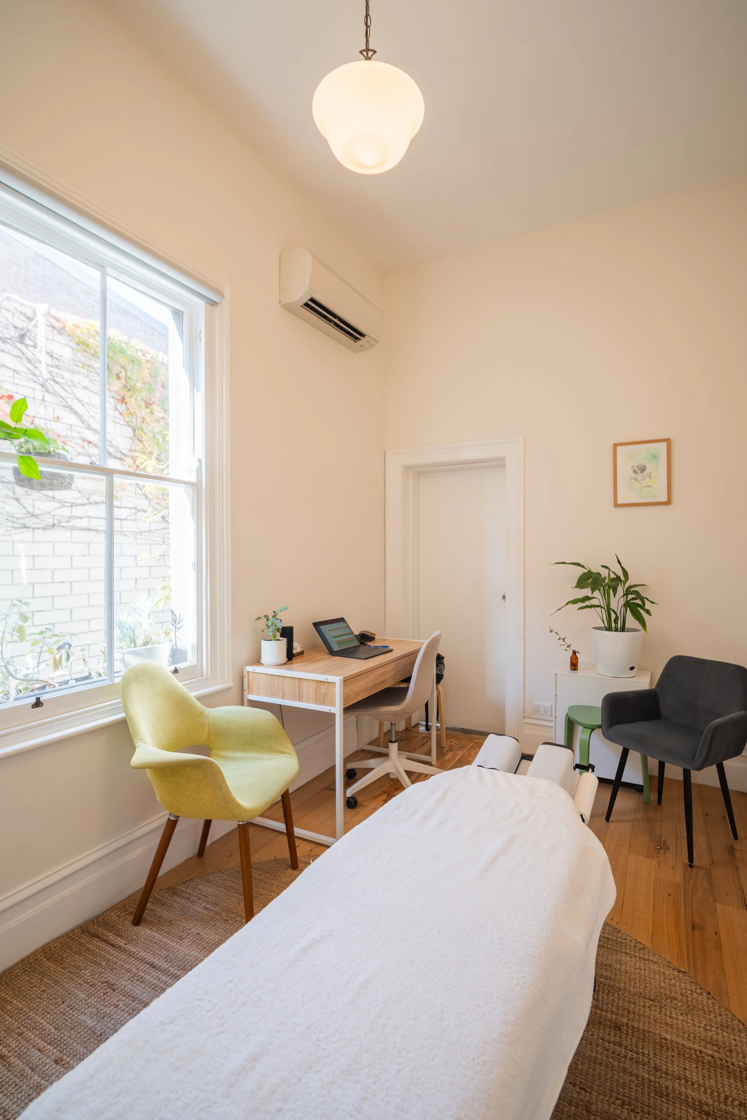 Bright consultation room with armchair and indoor plants at Four Seasons Wellness Centre Abbotsford Melbourne