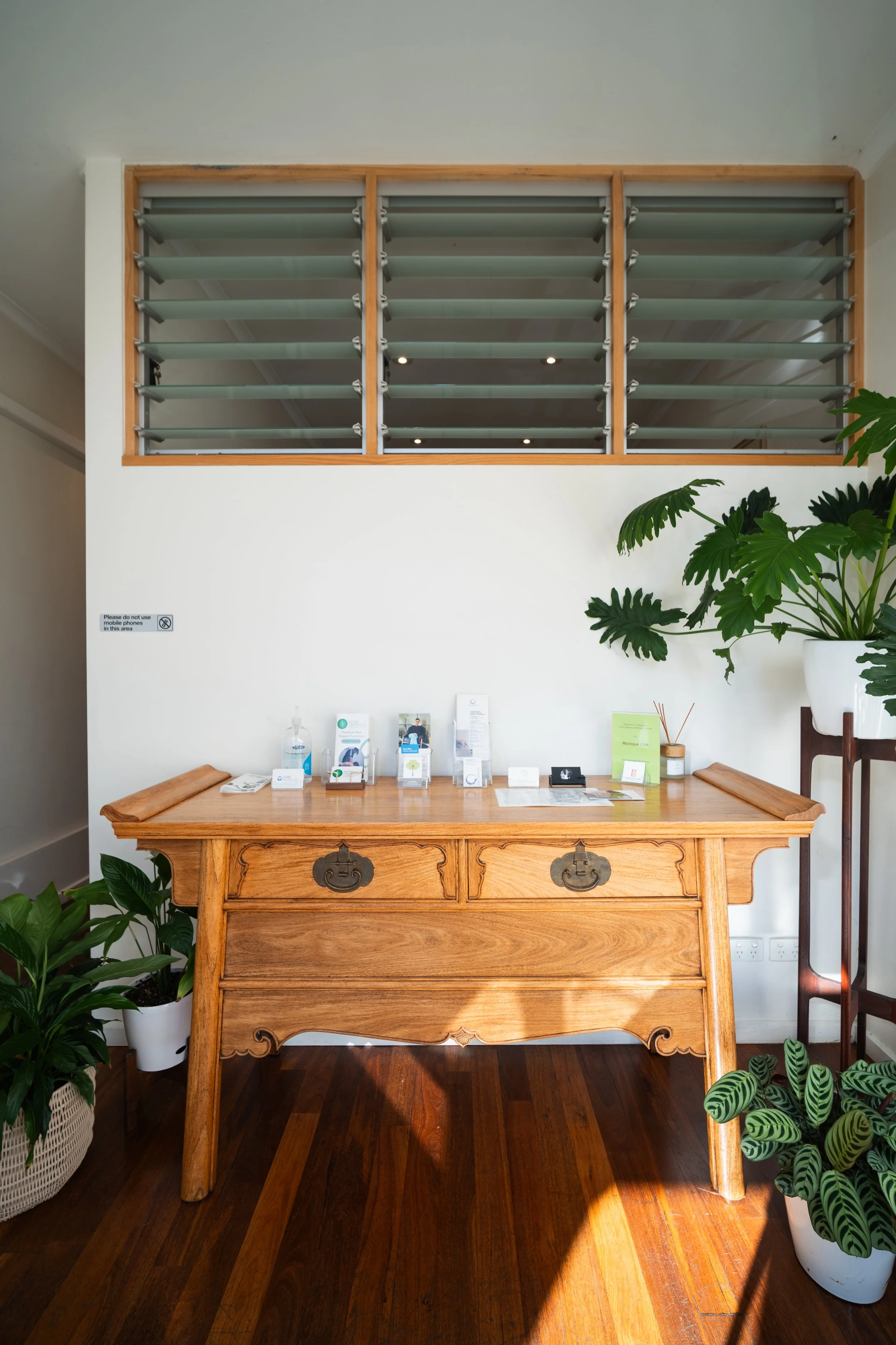 Timber dresser and indoor plants in treatment room at Four Seasons Wellness Centre Abbotsford Melbourne