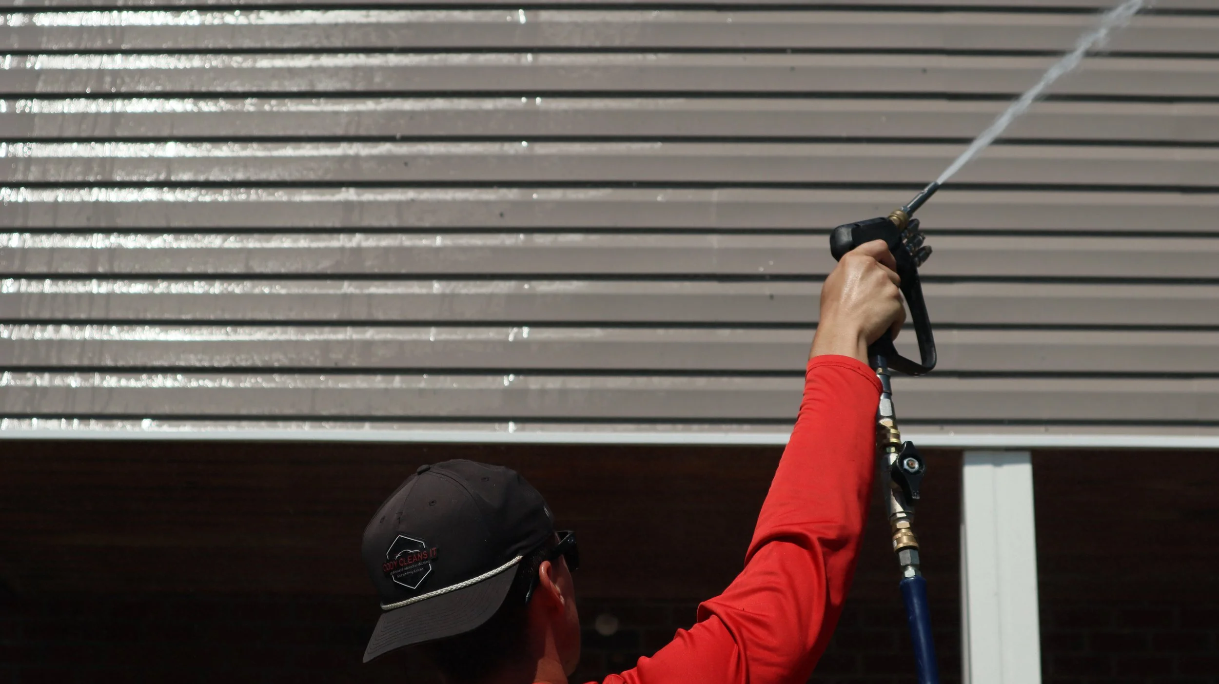 cody cleans it power washing a commerical building
