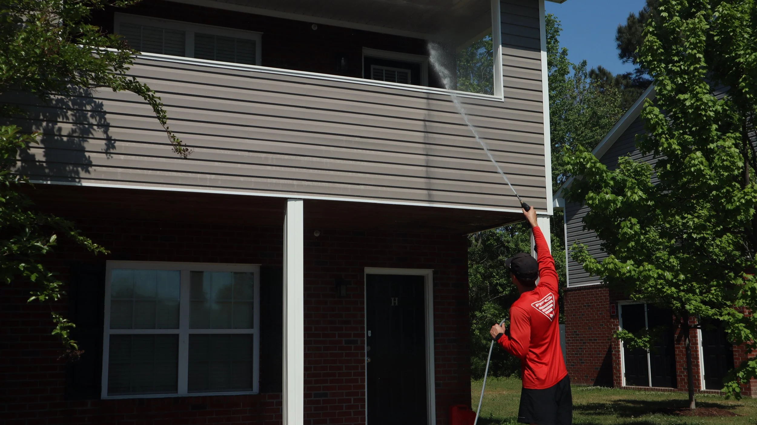 cody cleans it power washing a commerical building