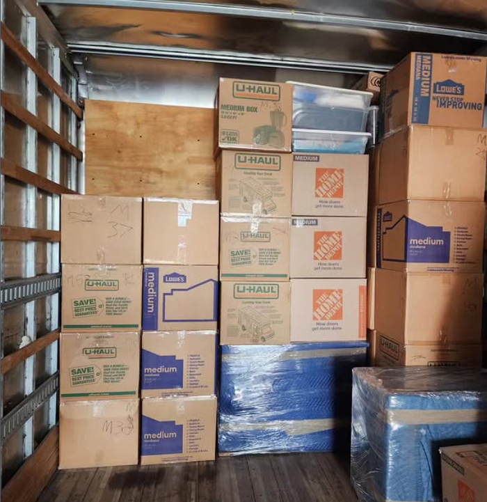 Stacked moving boxes inside a storage unit, delivered by 2nd chance moving copany and deliver