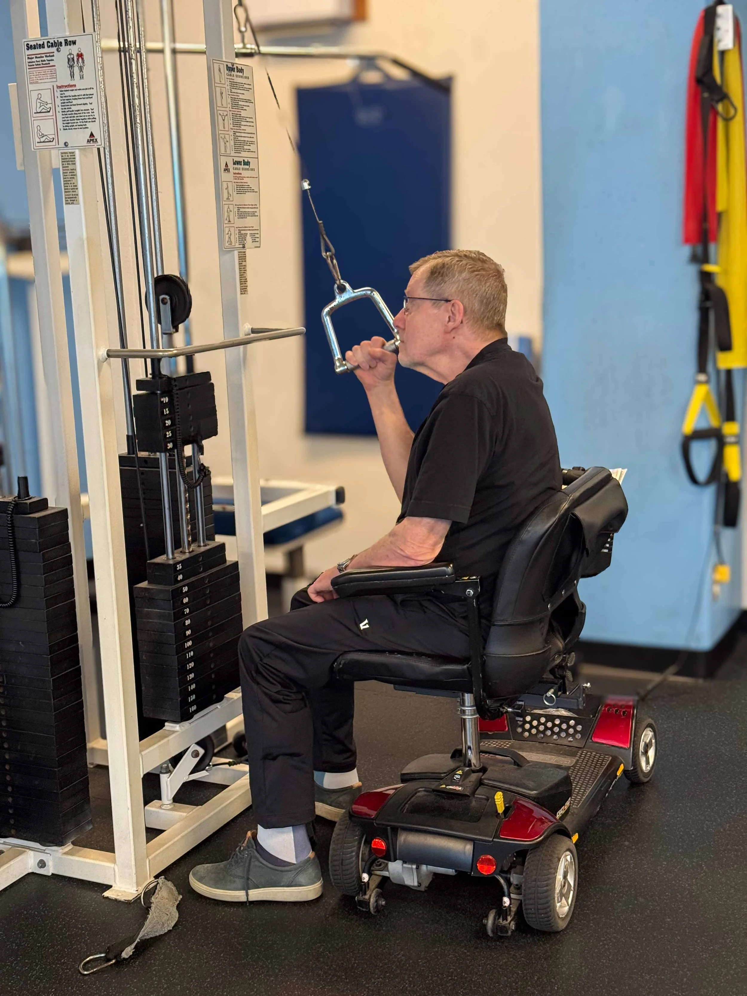 client with Multiple Sclerosis (MS) working on strengthening at the gym in Victoria BC