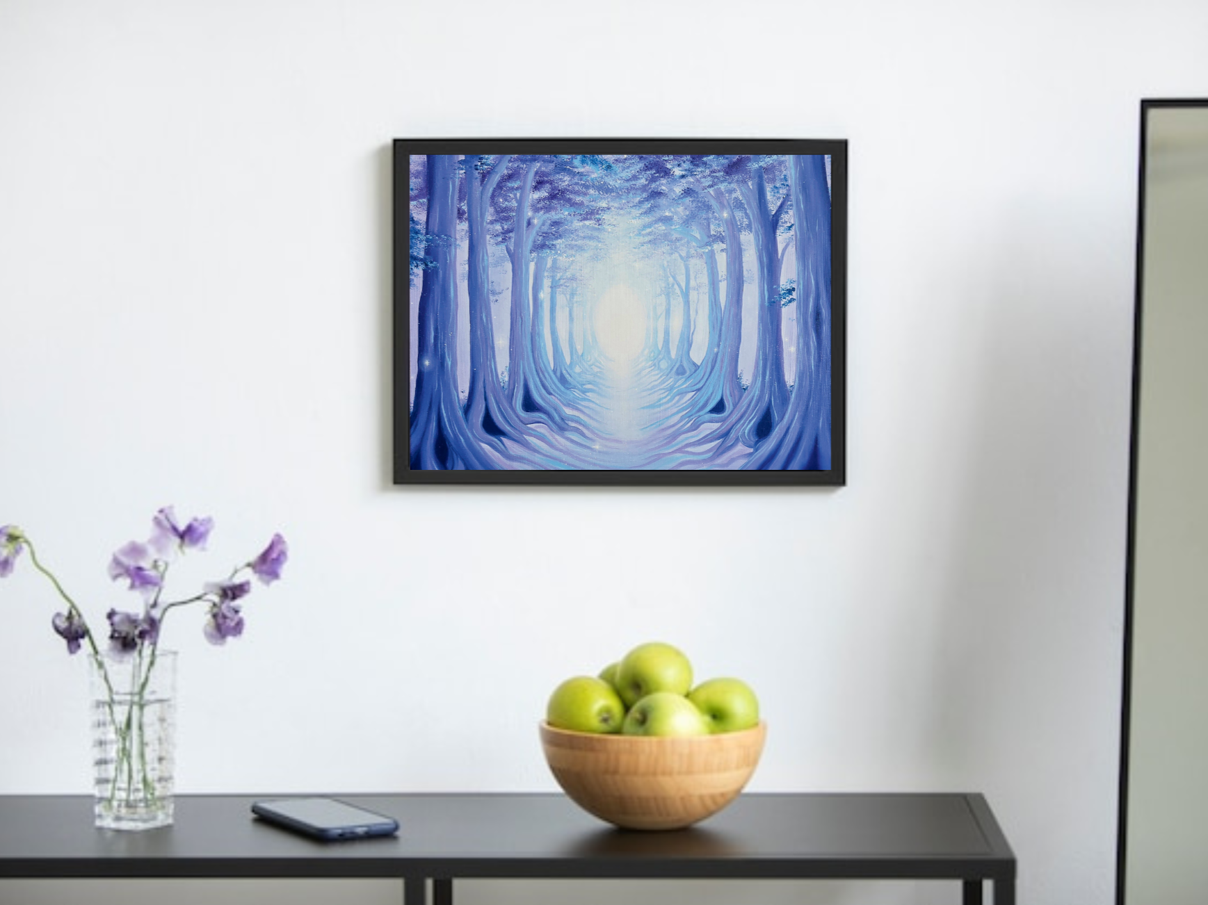 A modern minimalist living room, with a framed oil painting of a serene blue forest path hung on the wall. Peaceful forest painting, serene blue forest painting, forest with a pathway artwork. Peaceful purple dreamscape painting. Periwinkle décor. 