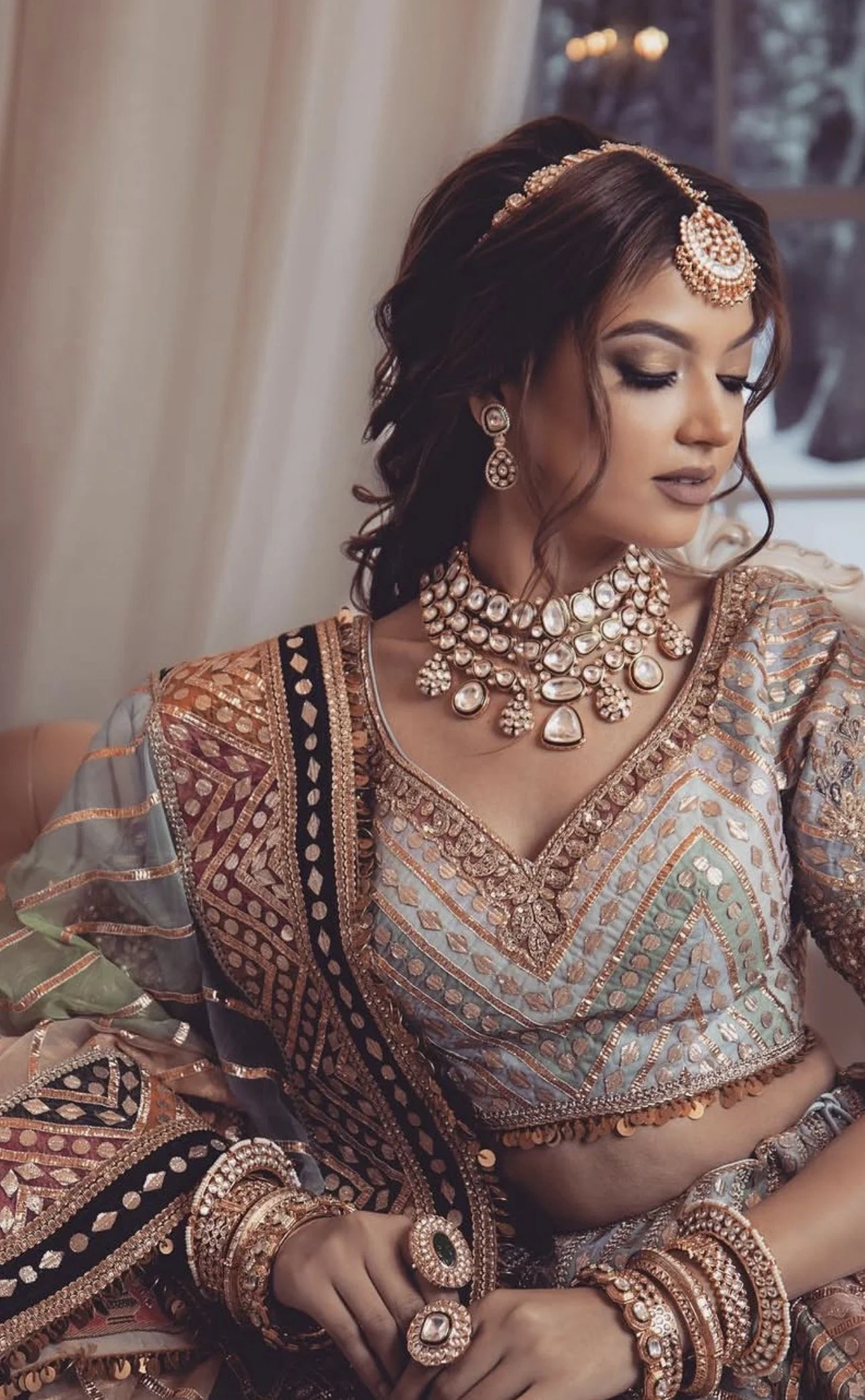 Indian bride wearing kundan bridal necklace and traditional jewelry styled for sangeet jago ceremony look.