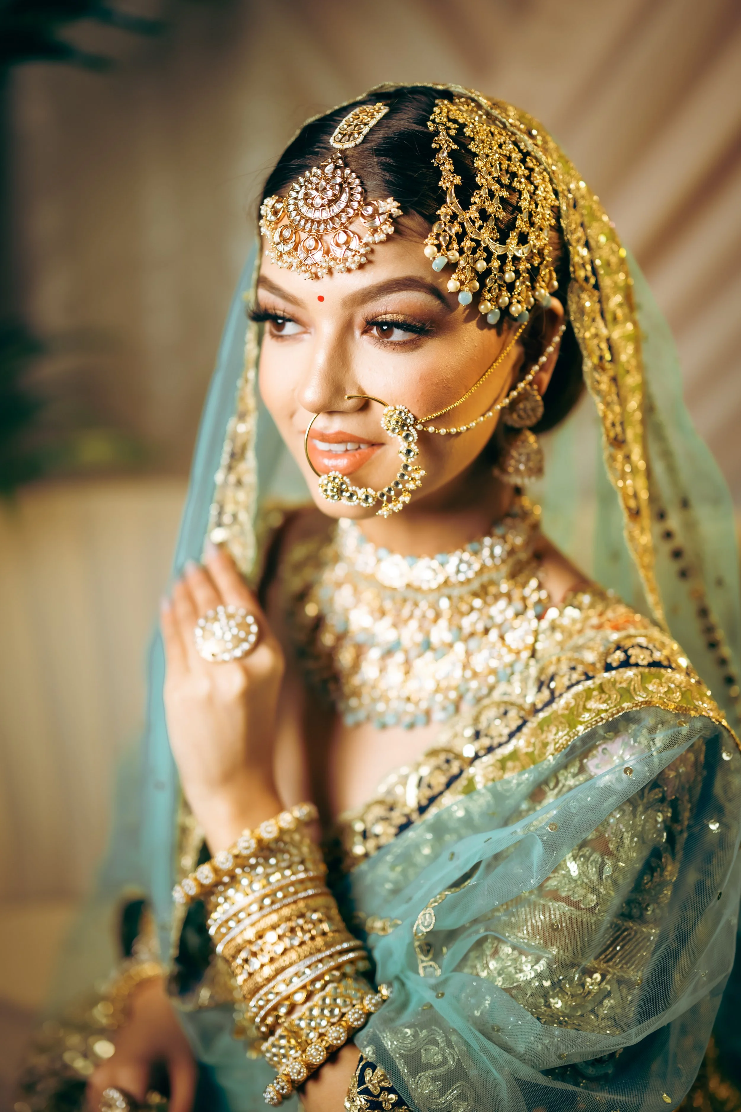 Indian bride wearing kundan bridal jewelry with nath and green dupatta styled for wedding look.
