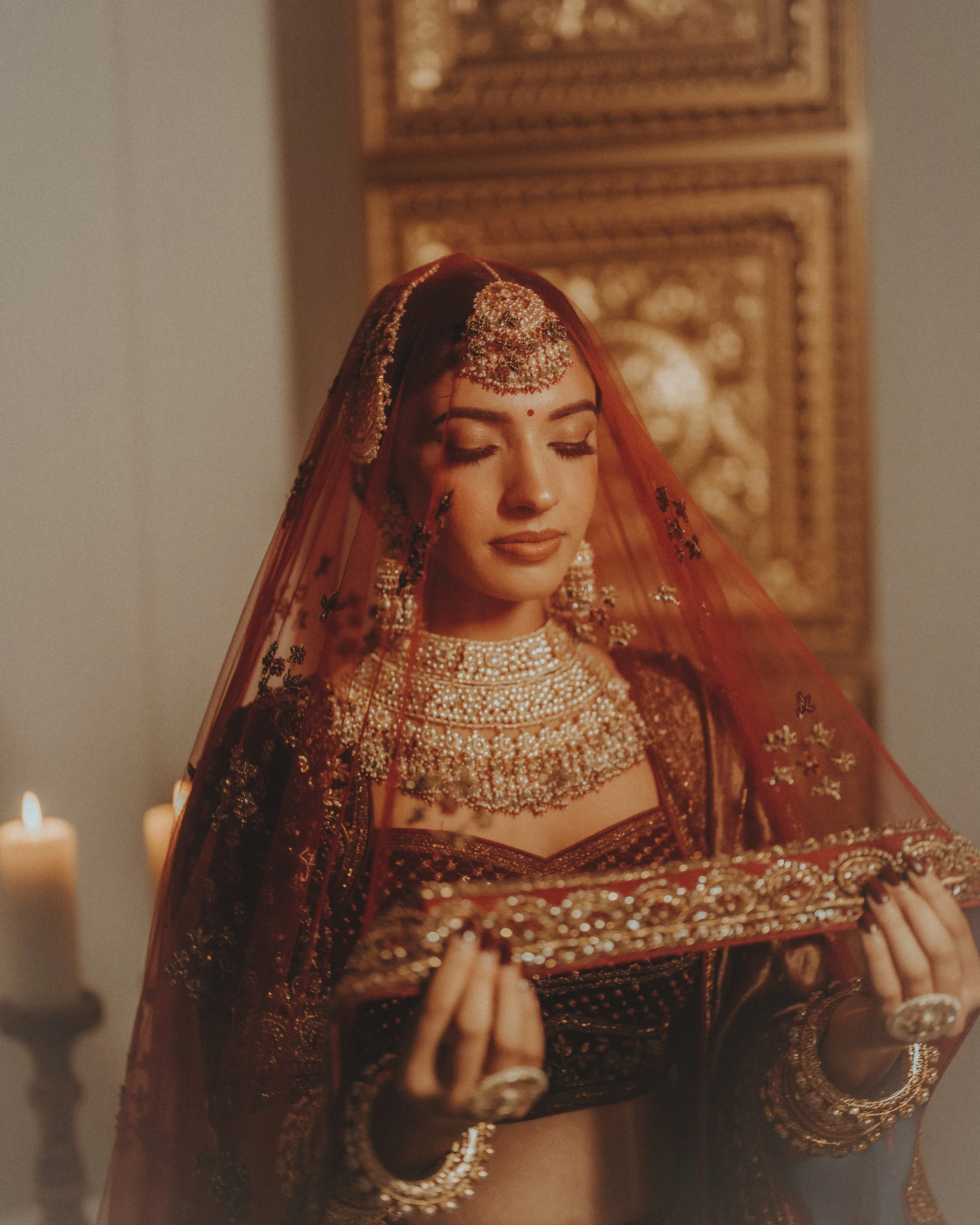 Indian bride wearing kundan bridal necklace and traditional jewelry with veil, styled for wedding ceremony look.