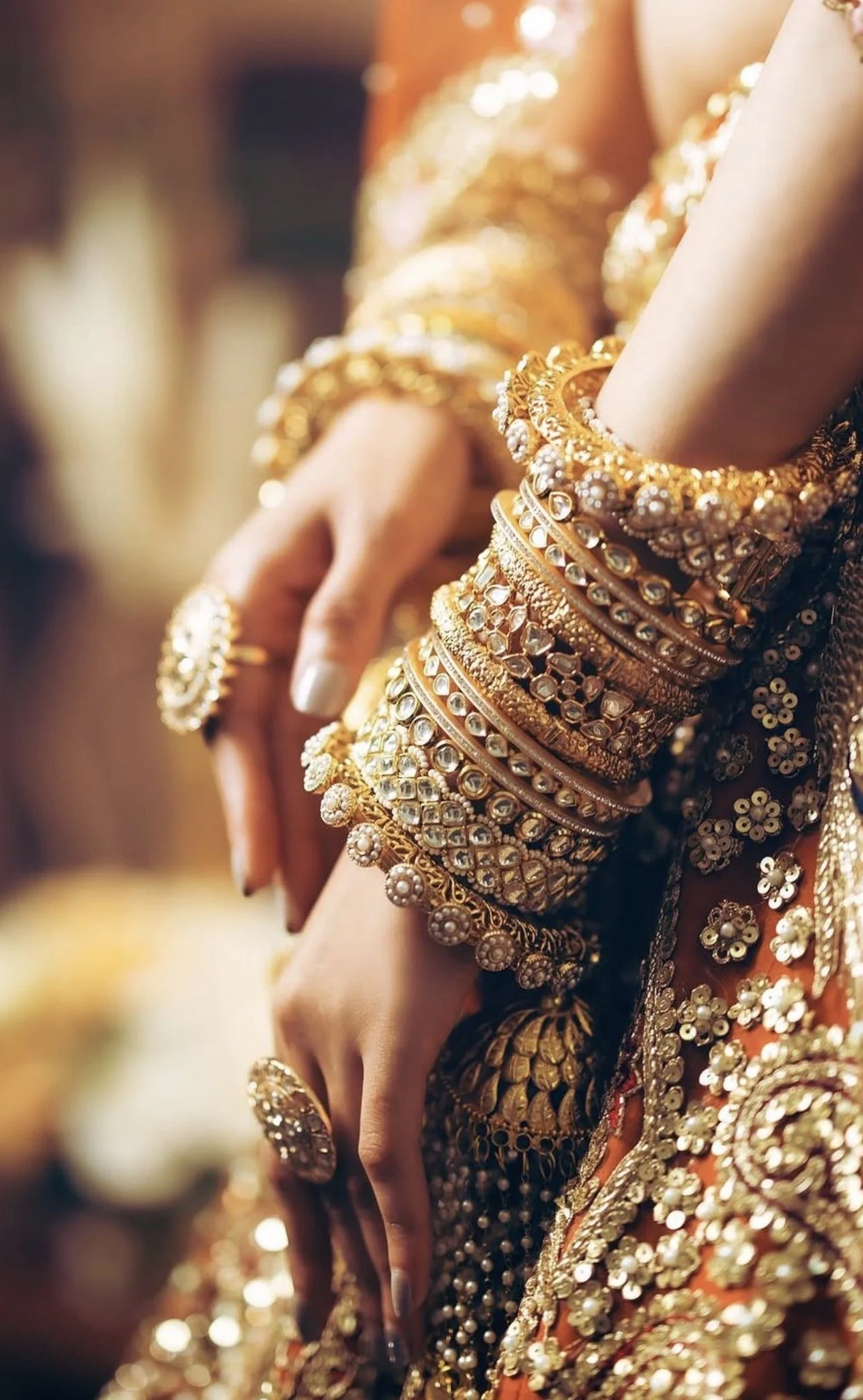 Detailed view of bridal choora and gold bangles styled with kaleeray for wedding ceremony look