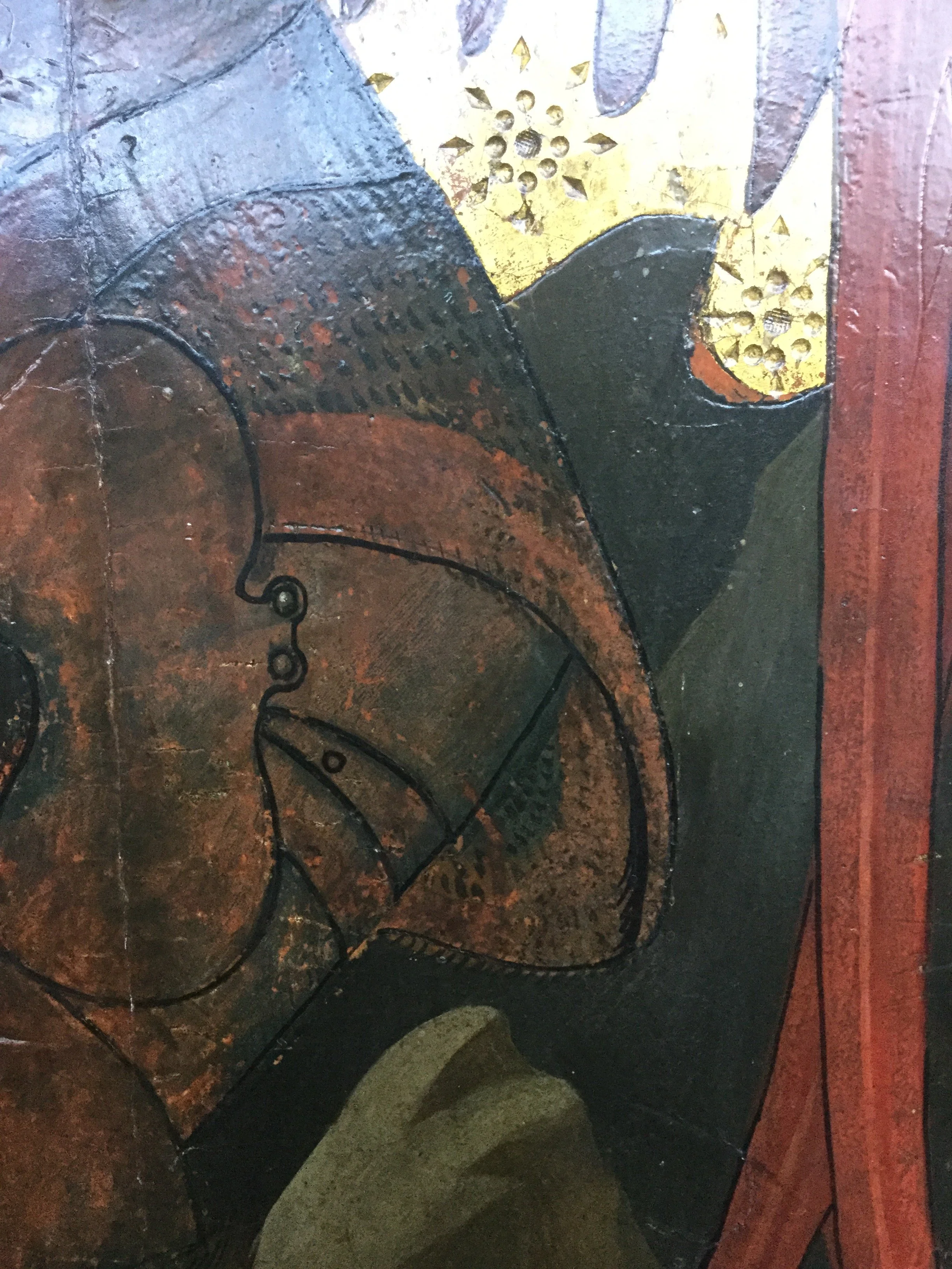 Detail of discolored varnish and paint and tarnished silver leaf in 15th century panel painting