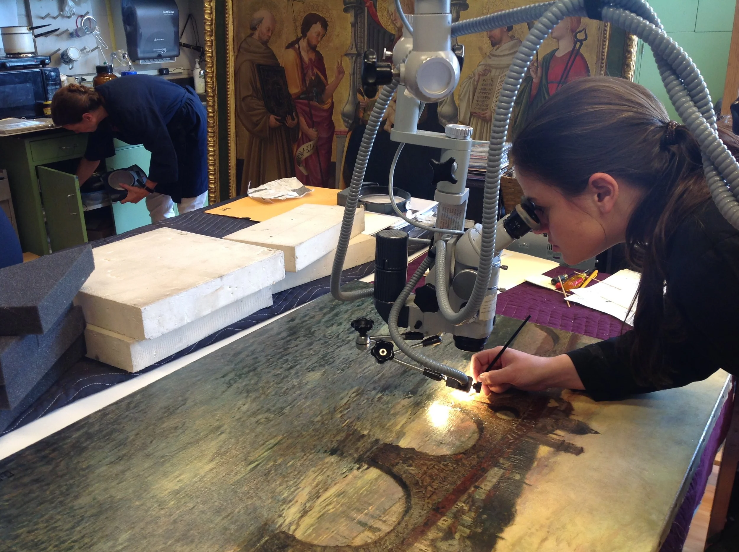 Consolidating a loss in an oil painting under magnification - Image courtesy of Eric Gordon