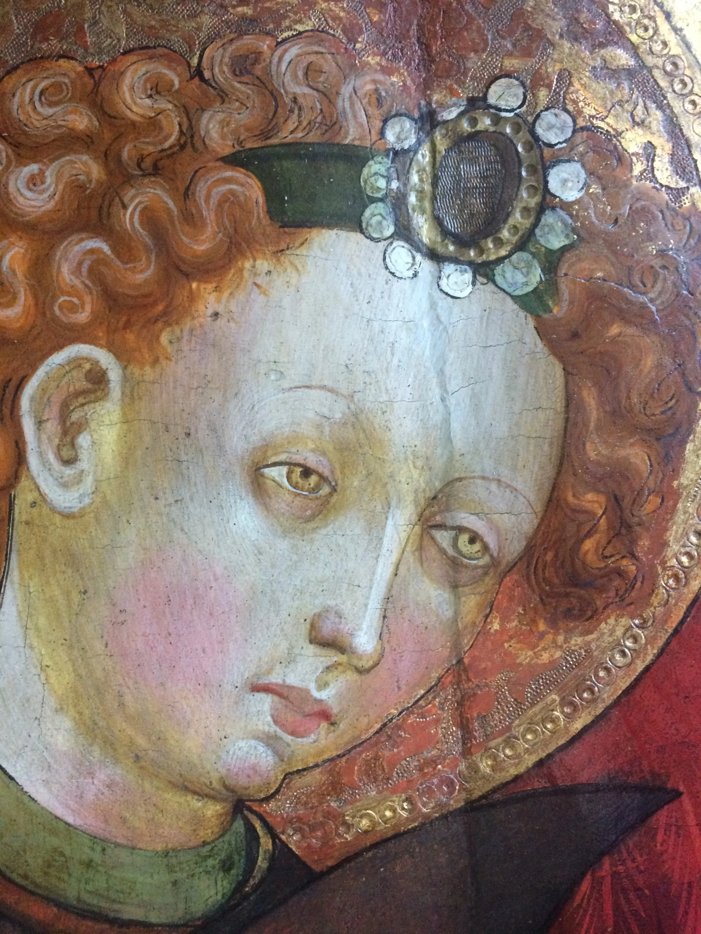Detail of face and join area in 15th century panel painting during treatment