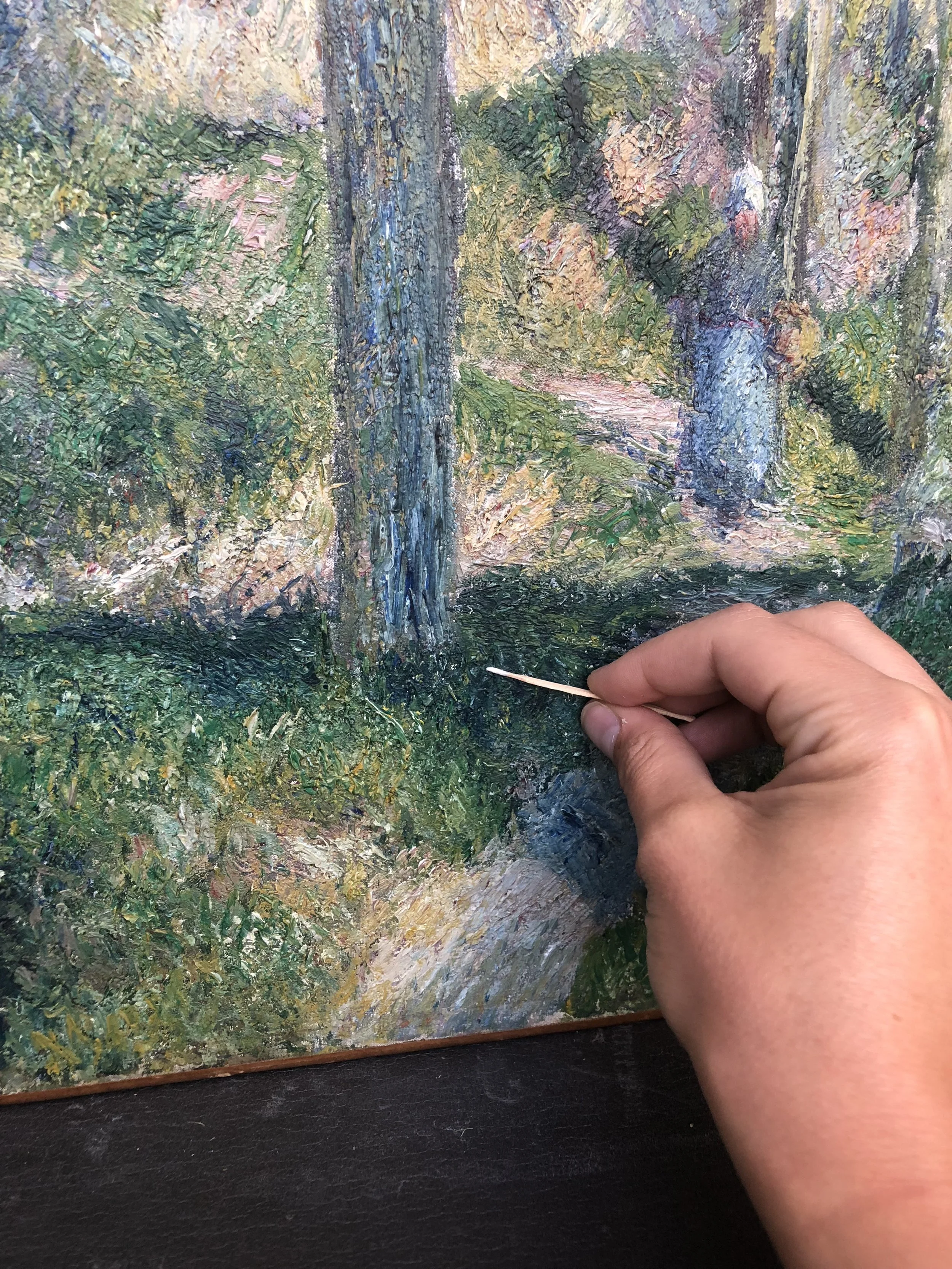 Removing discolored varnish from interstices of impasto on a Pissarro