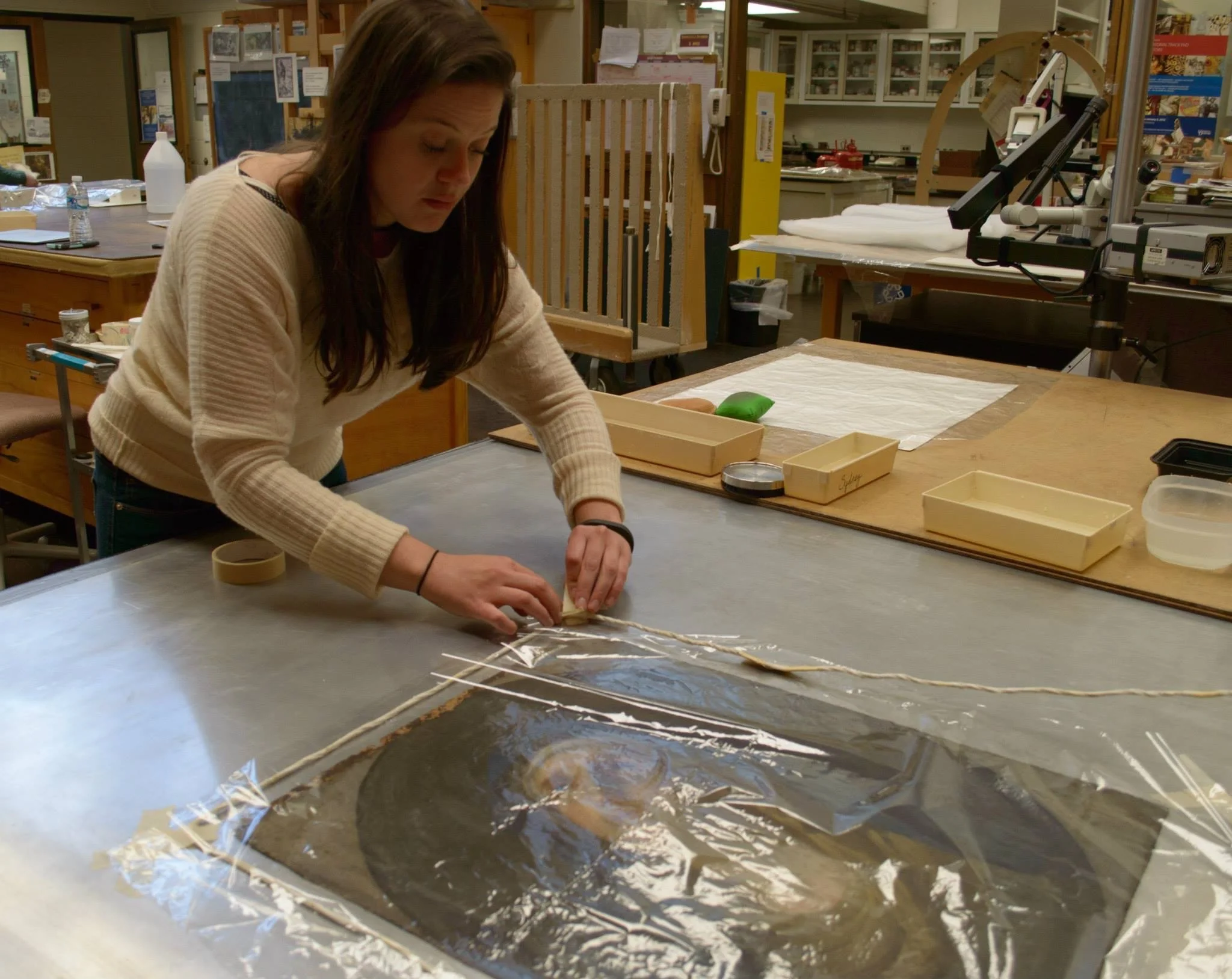 Preparing a painting for lining on a hot table. - Image courtesy of Pam Johnson