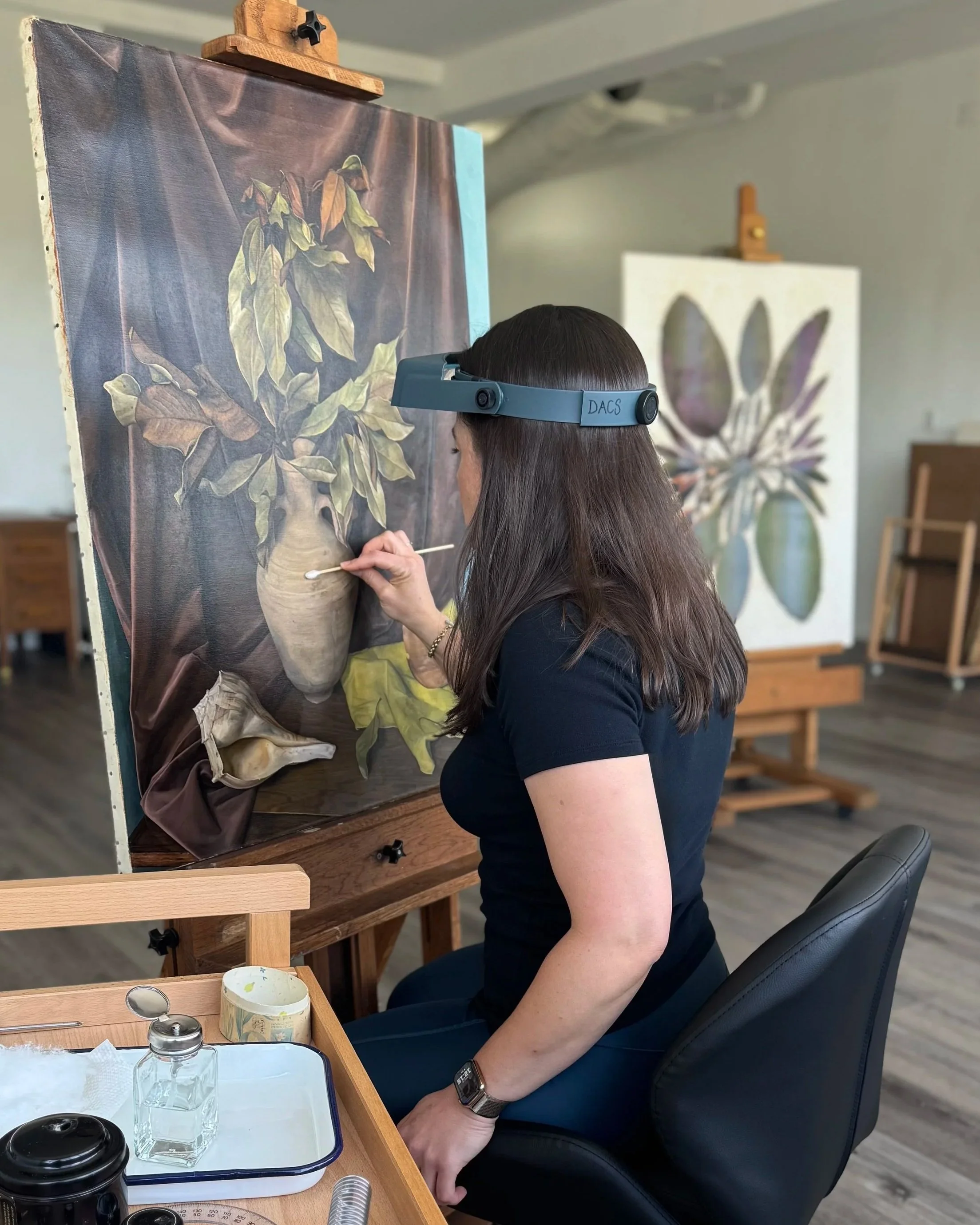 Miranda removing discolored varnish from a Lucioni