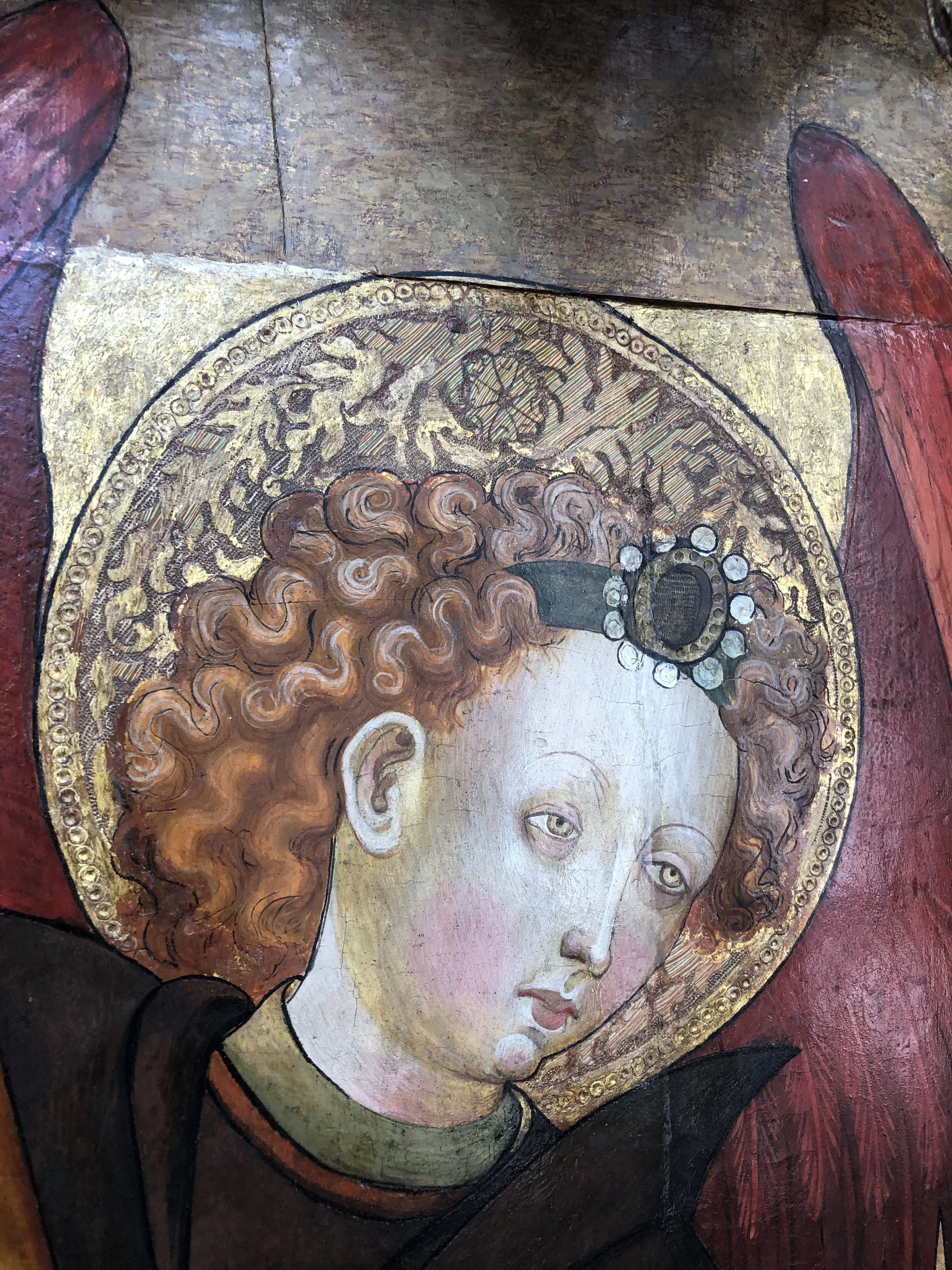Detail of tratteggio-style loss compensation in 15th century panel painting.  This allows the eye to rest, but does not trick the viewer into thinking this area is original. 
