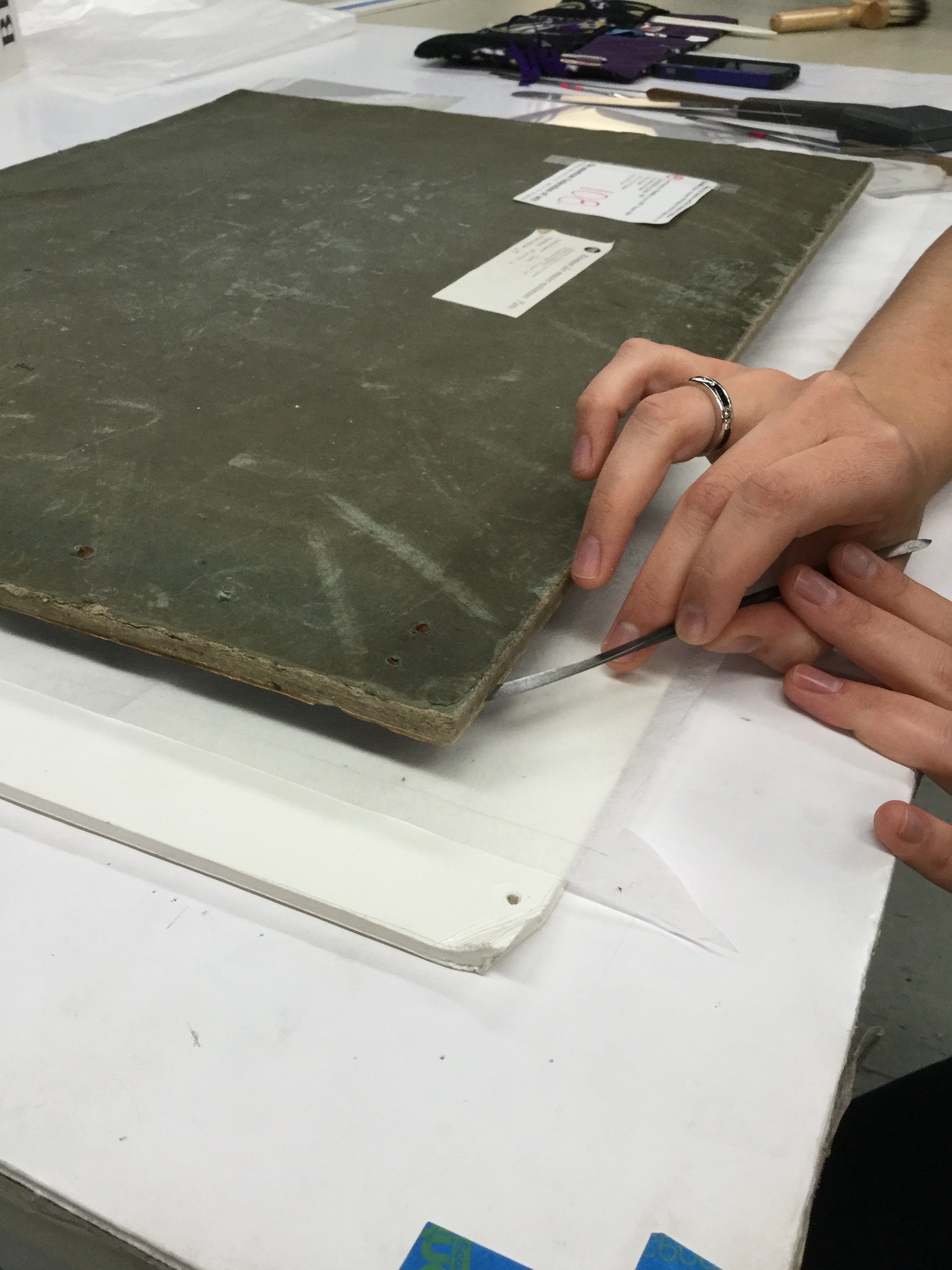 Removing a French oil sketch from a bowed board support - Image courtesy of Elma O'Donoghue