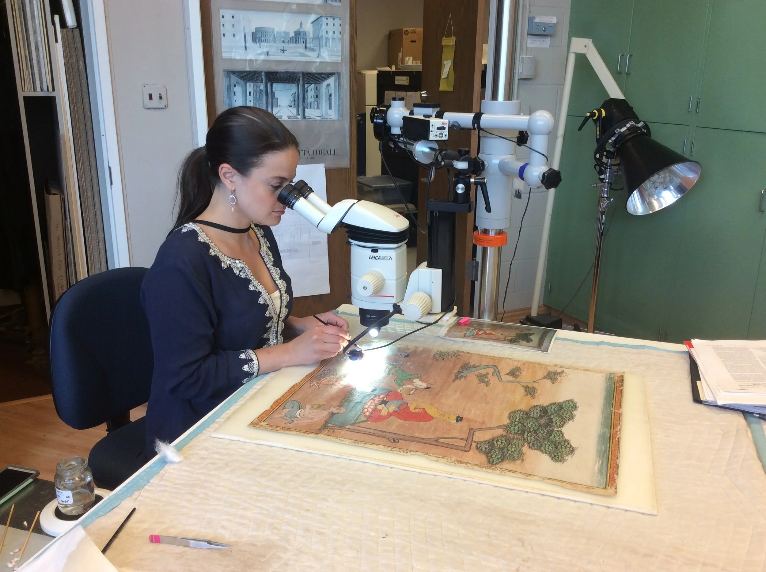 Consolidating an underbound paint layer on a Thai painting - Image courtesy of Pam Betts