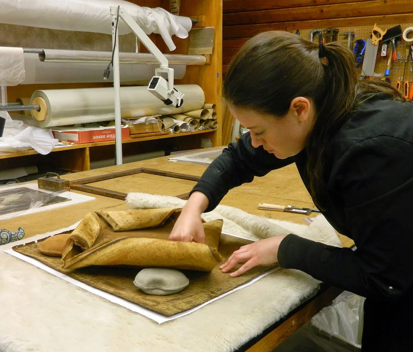 Removing a failing lining canvas from an 18th century oil painting - Image courtesy of Pam Johnson