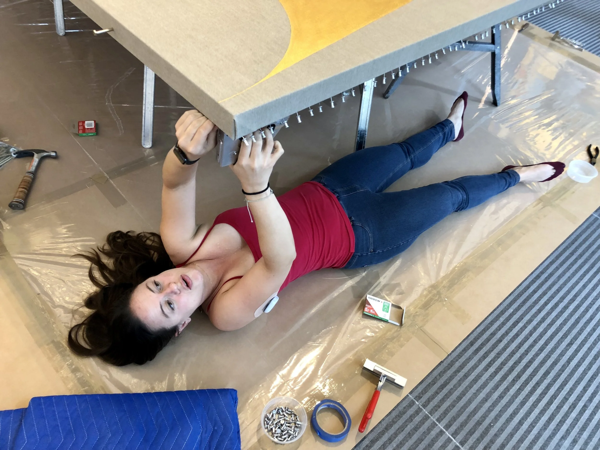 Pinning out an oversized painting after unrolling and stretching - Image courtesy of Susanne Friend