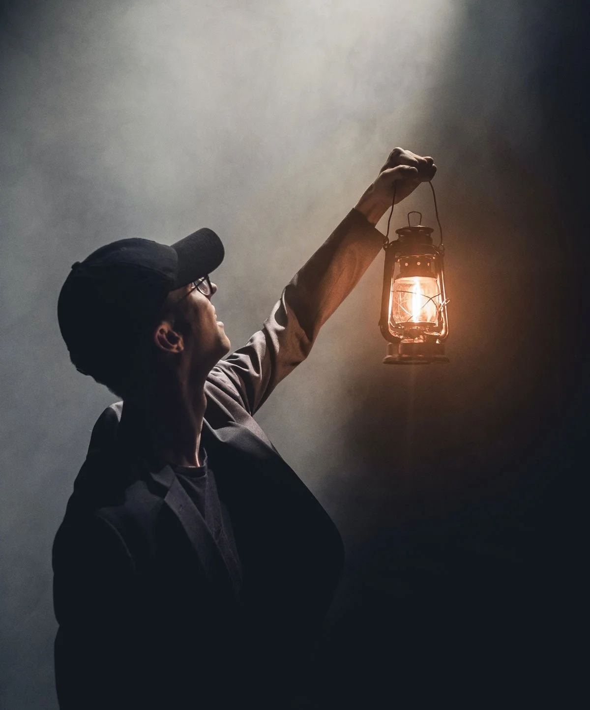 A man holding up a lantern