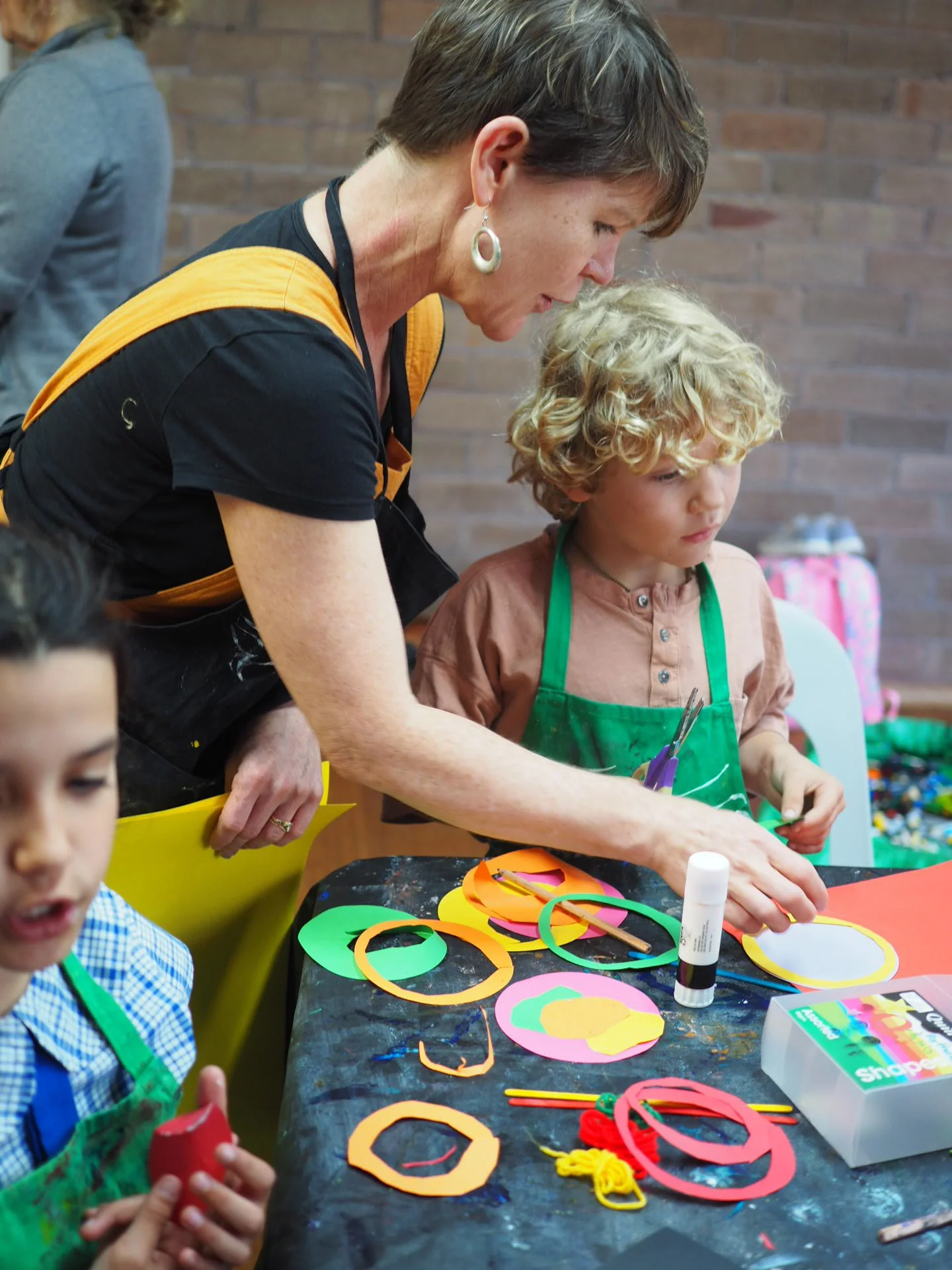 A child and art teacher working together on a art project at a children's art class in Bundeena, Sydney