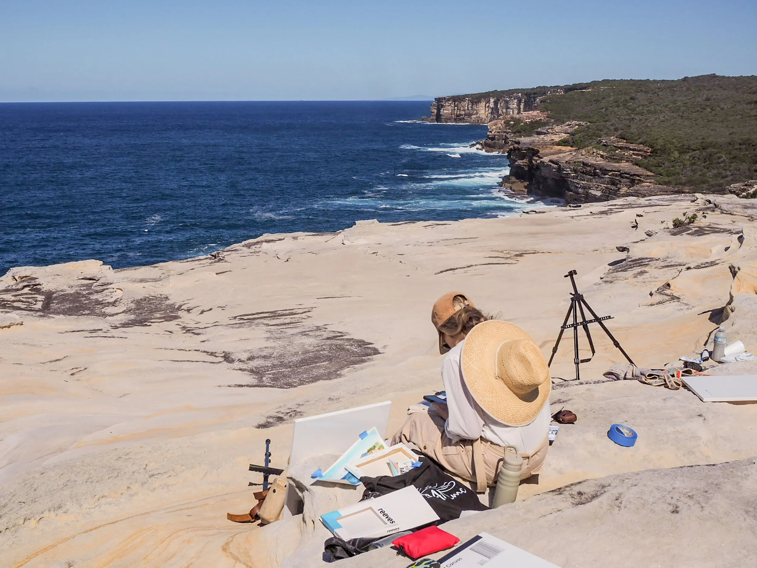 A woman painting en pleain air at a workshop at the Balconies, Bundeena, Royal National Park, Sydney.