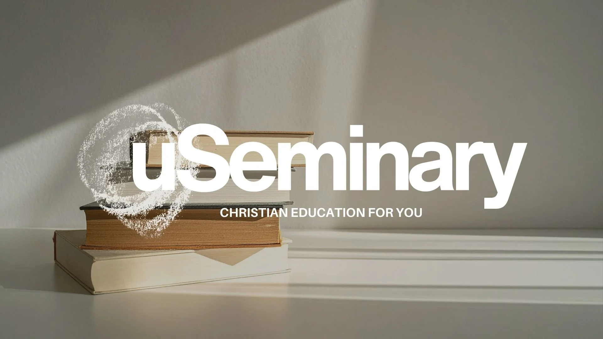 Stack of three books on a white surface with a plain gray wall background, with time shadow and the text 'uSeminary CHRISTIAN EDUCATION FOR YOU' overlayed.