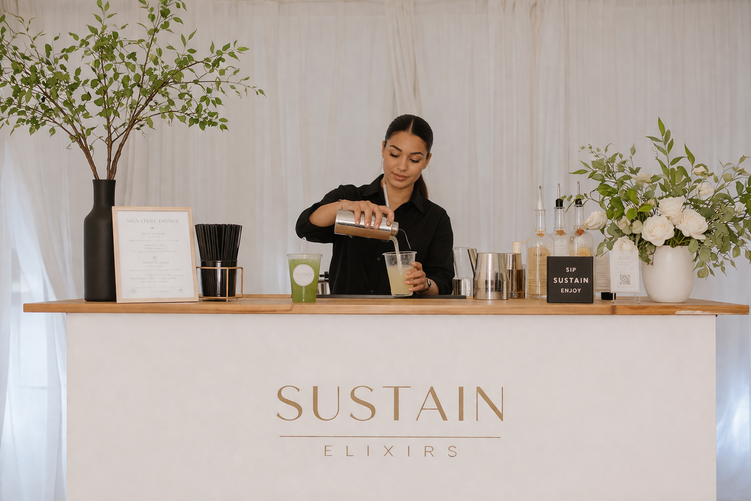 A woman making a cocktail at a bar with the word 'SUSTAIN' on the front, decorated with green plants and flowers.