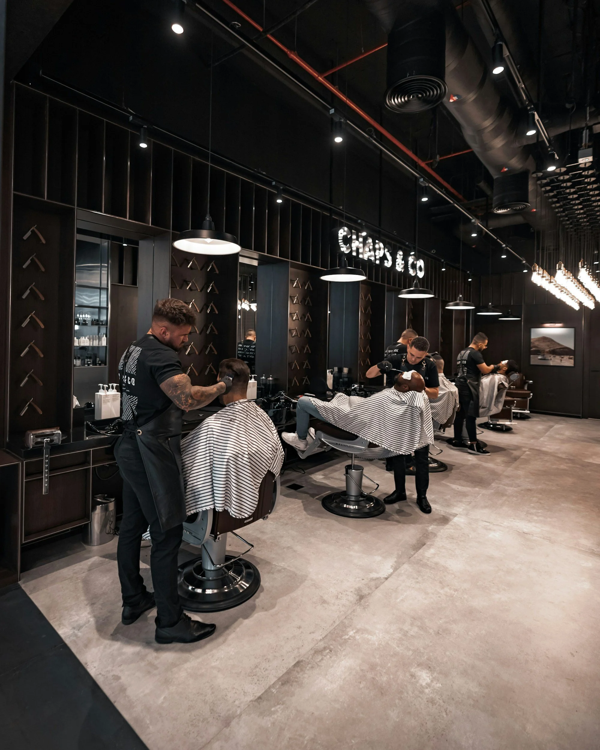 barbers giving haircuts in barbershop