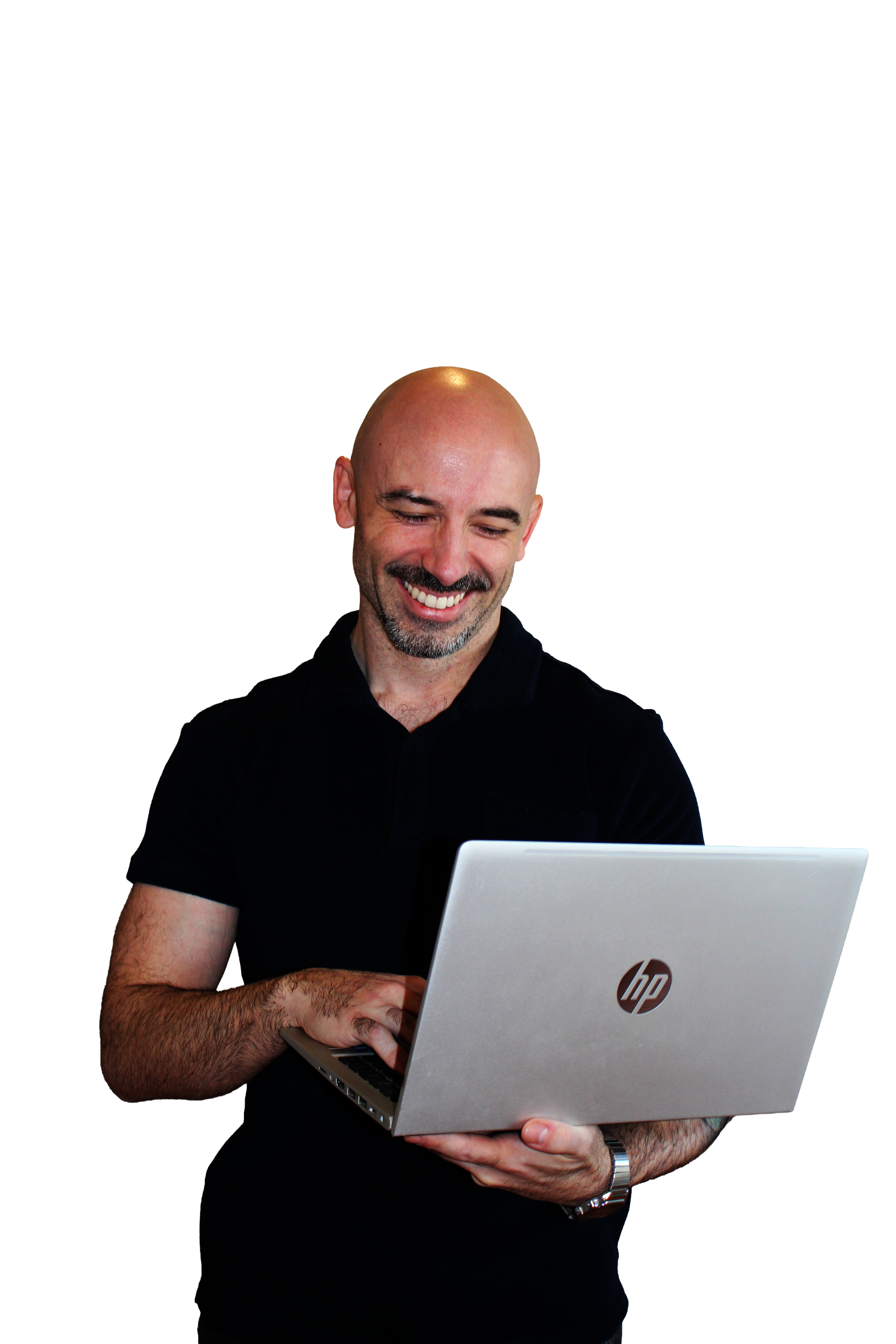 A smiling, bald man with a beard, wearing a black shirt, holding a silver HP laptop, looking at the screen.
