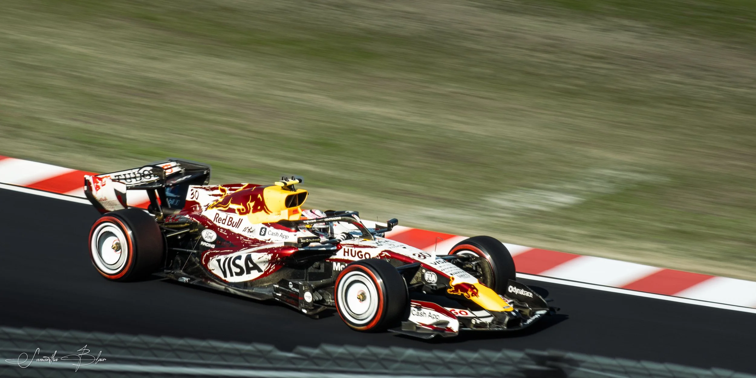 VCARB 2026 Formula 1 Car taking Suzuka's Spoon Curve, captured by Samantha Blair