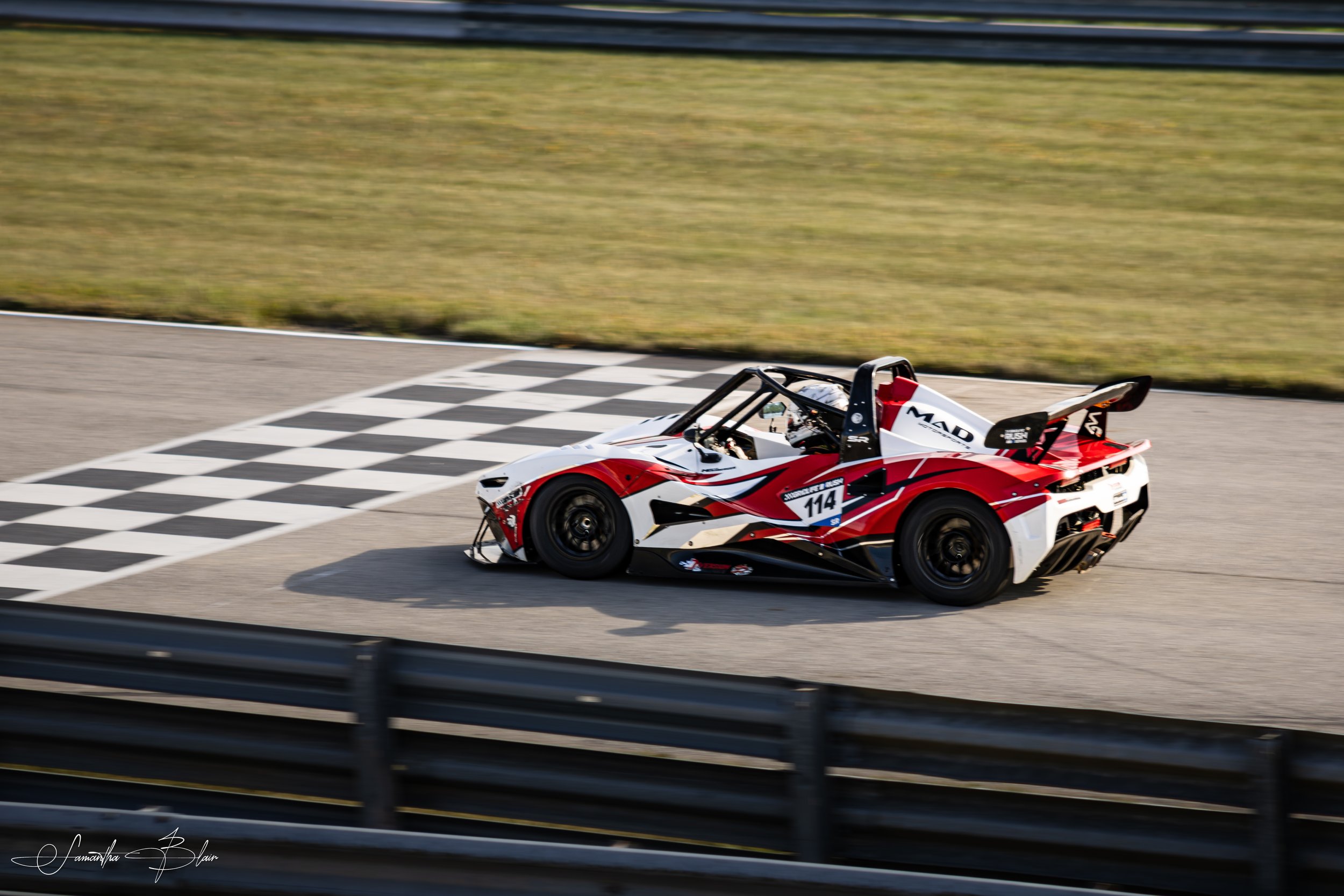 A Rush SR crossing the finish line at Gridlife Chicago 2026, captured by Samantha Blair