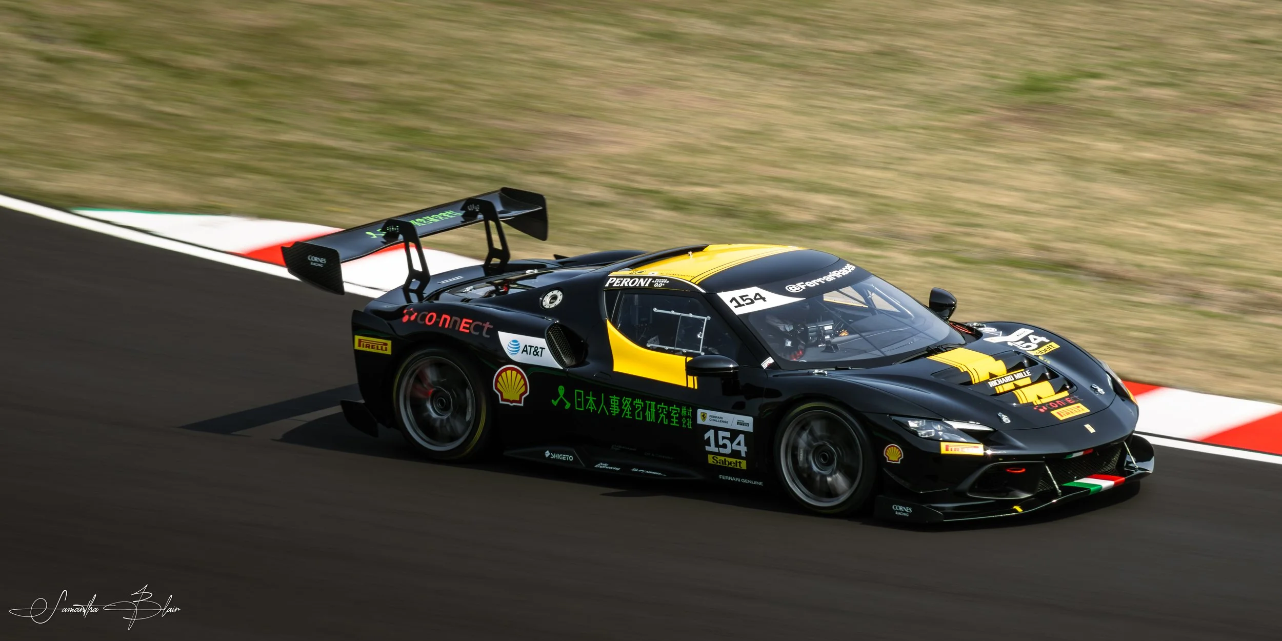 Ferrari 296 GT3 taking Suzuka's Spoon Curve, captured by Samantha Blair