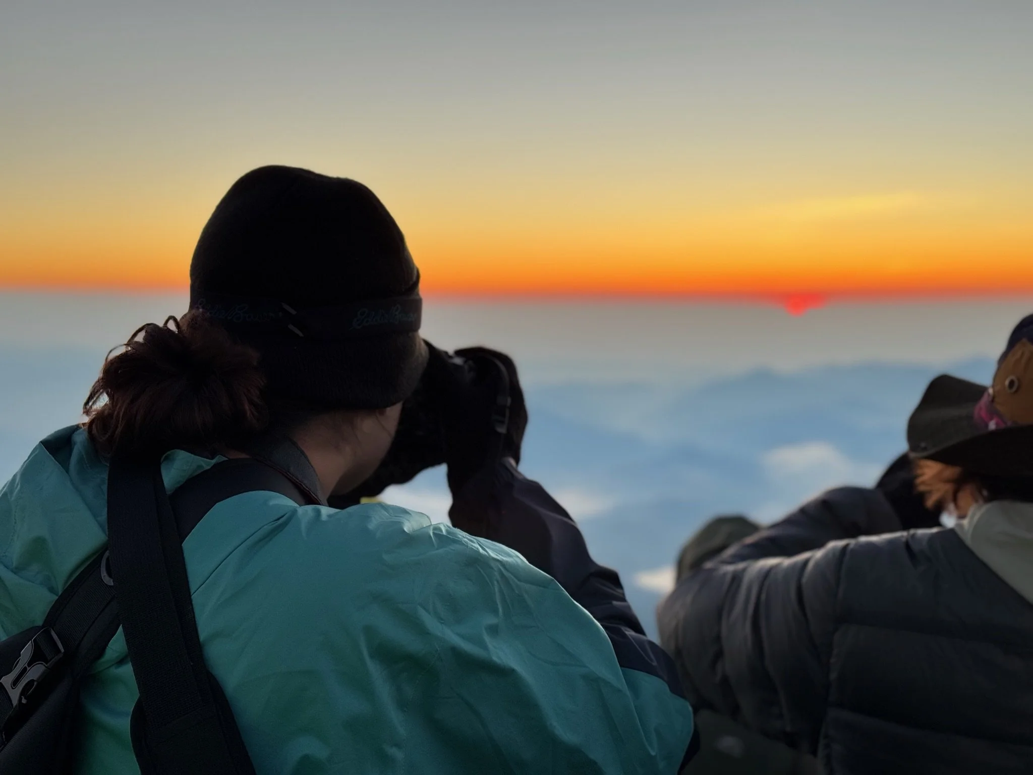 Samantha Blair, motorsports photographer based out of Northern Illinois, taking a photo on top of Mount Fuji of the sunrise.