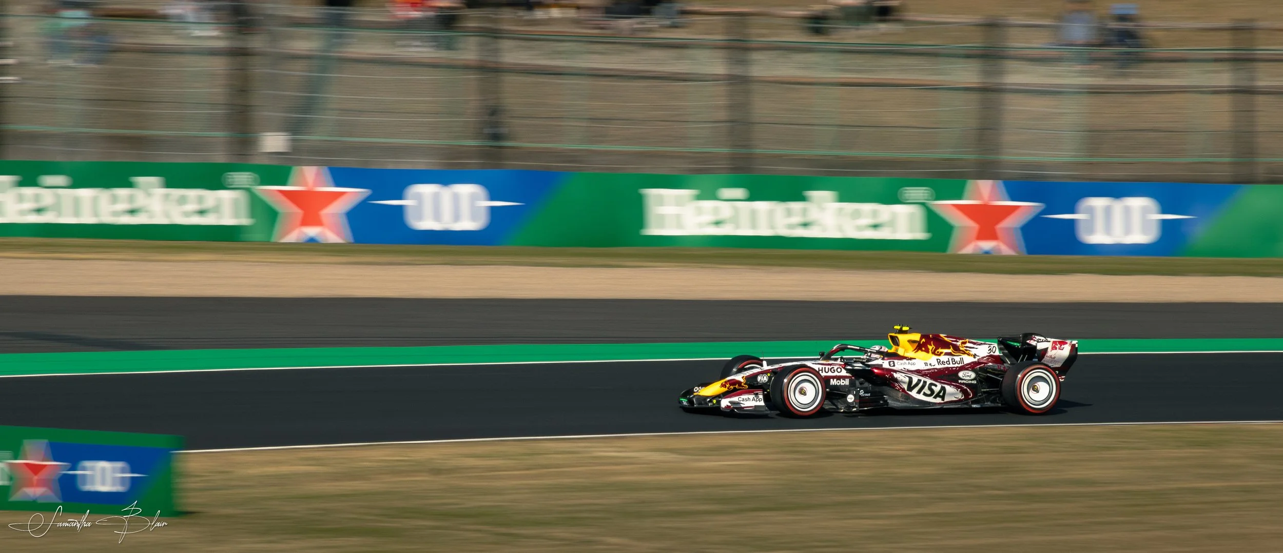 VCARB 2026 Formula 1 Car taking Suzuka's Spoon Curve, captured by Samantha Blair