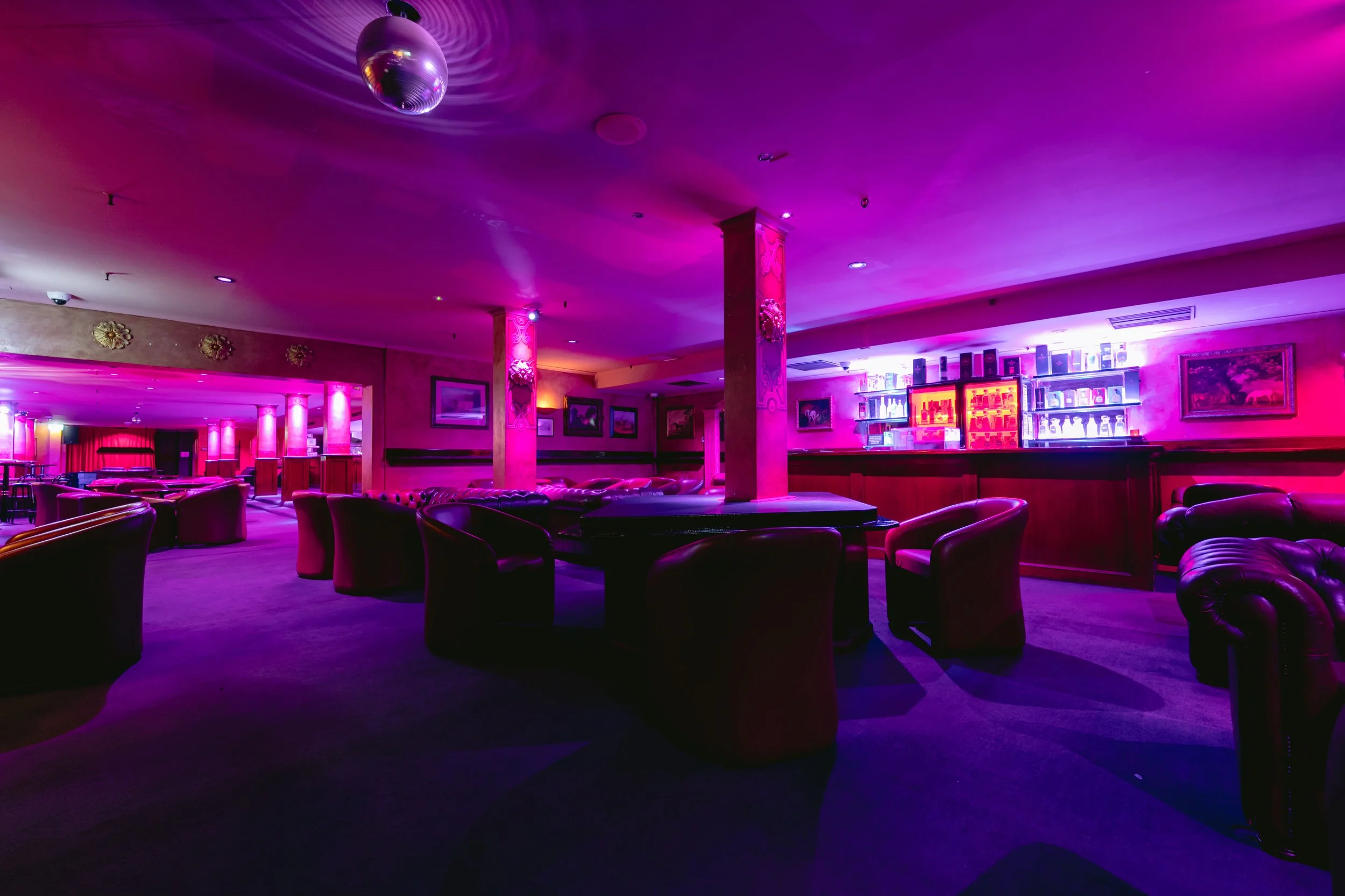 Bar seating with disco ball lighting at The Men's Gallery Melbourne strip club