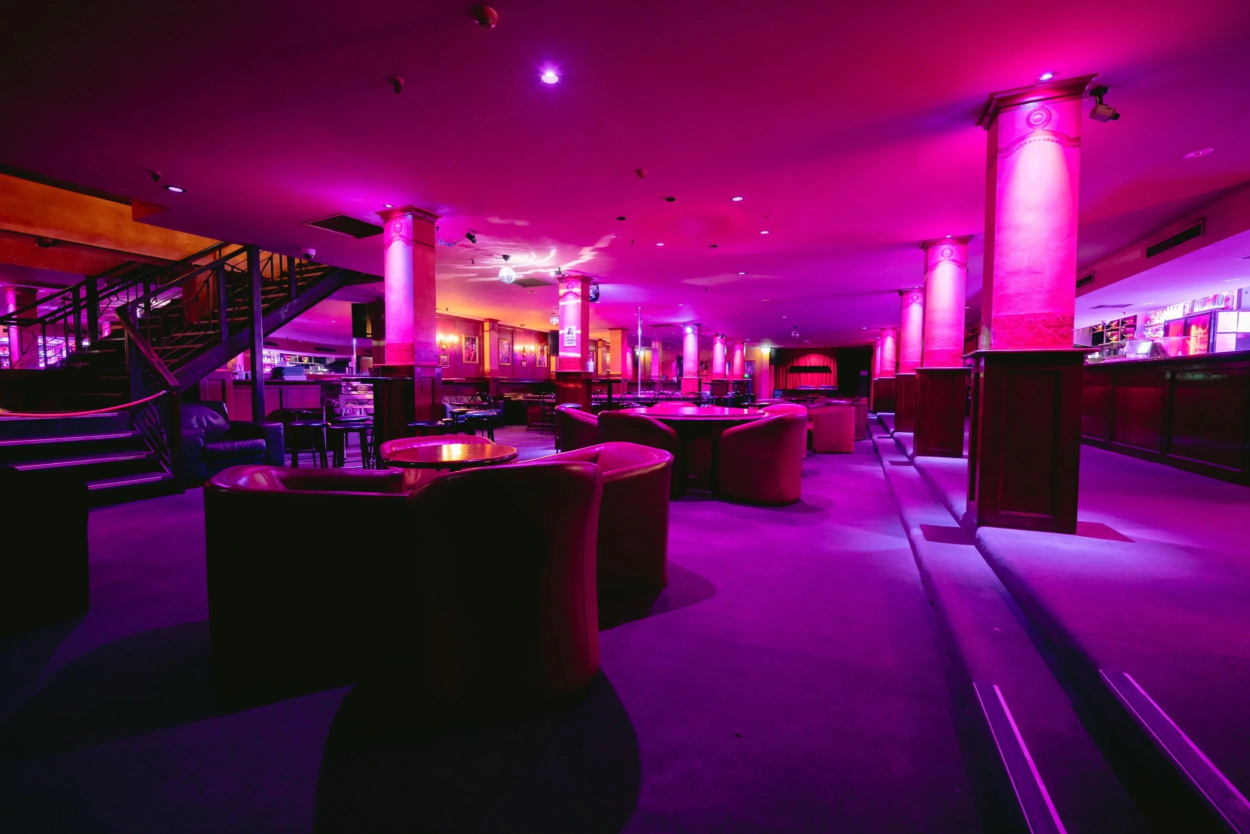 Lounge seating and staircase inside The Men's Gallery Melbourne strip club venue